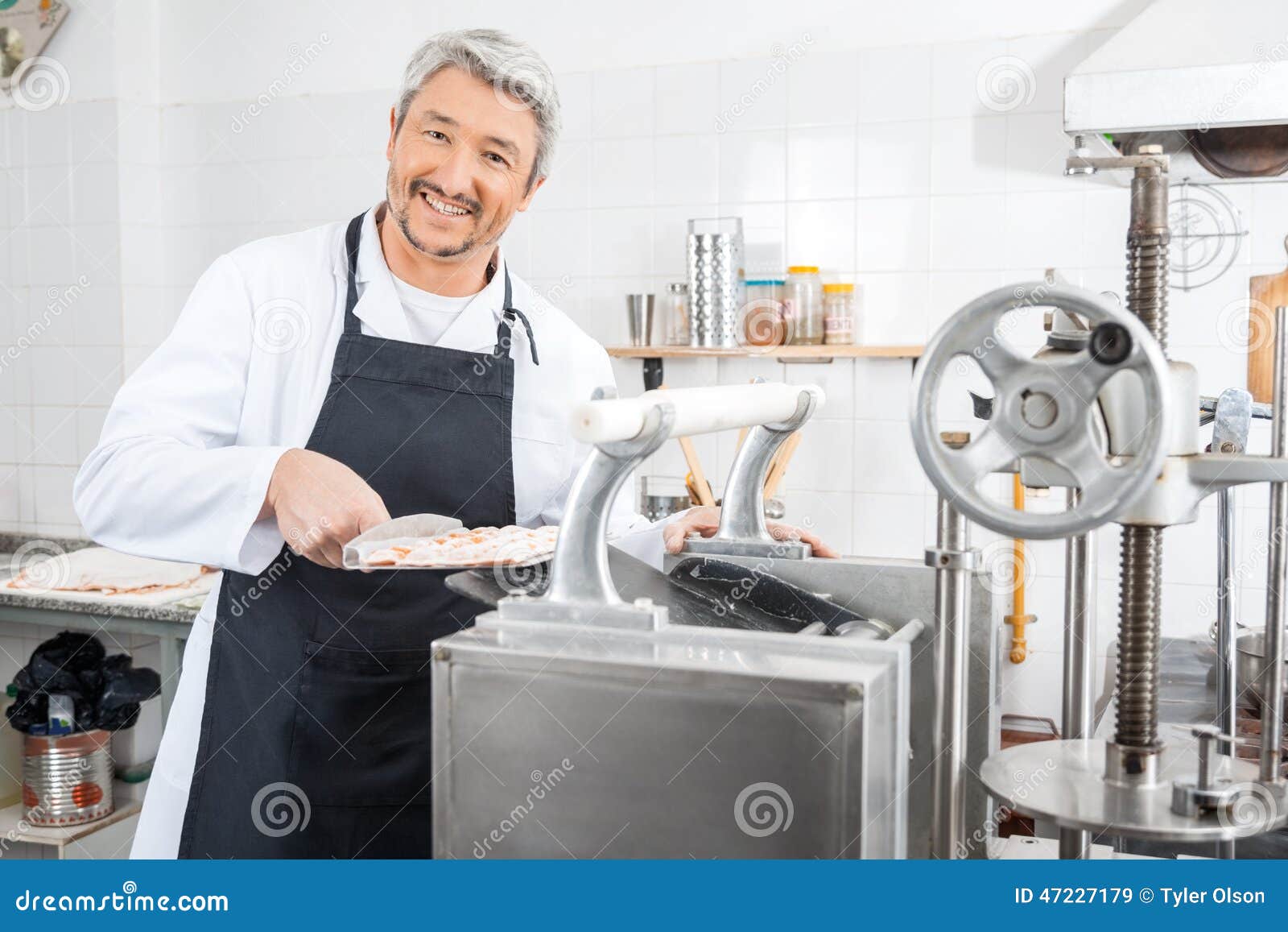 Happy Chef Processing Ravioli Pasta in Machine Stock Image - Image of