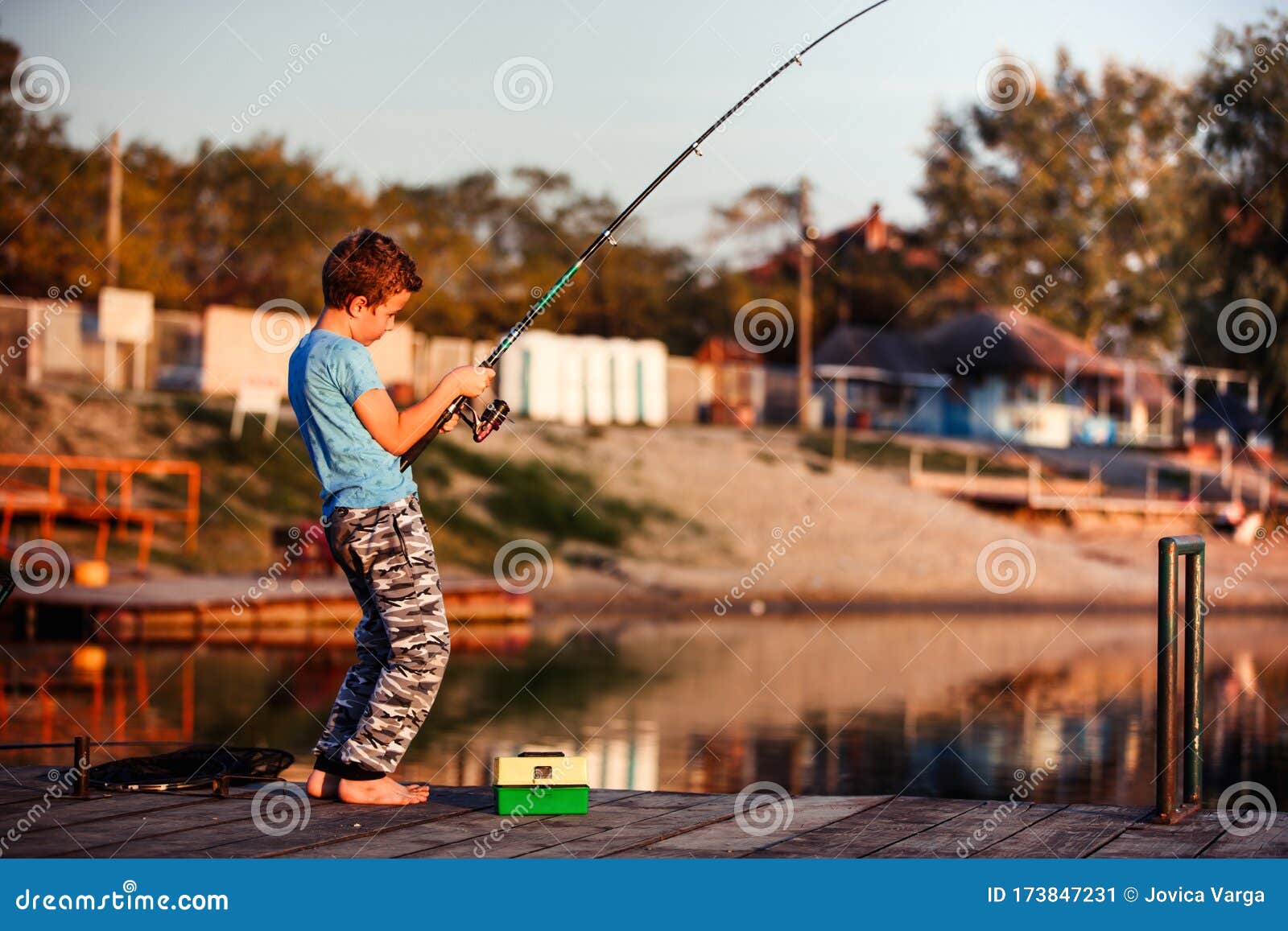 Happy Child Fishing on a Lake in a Sunny Summer Day Stock Image