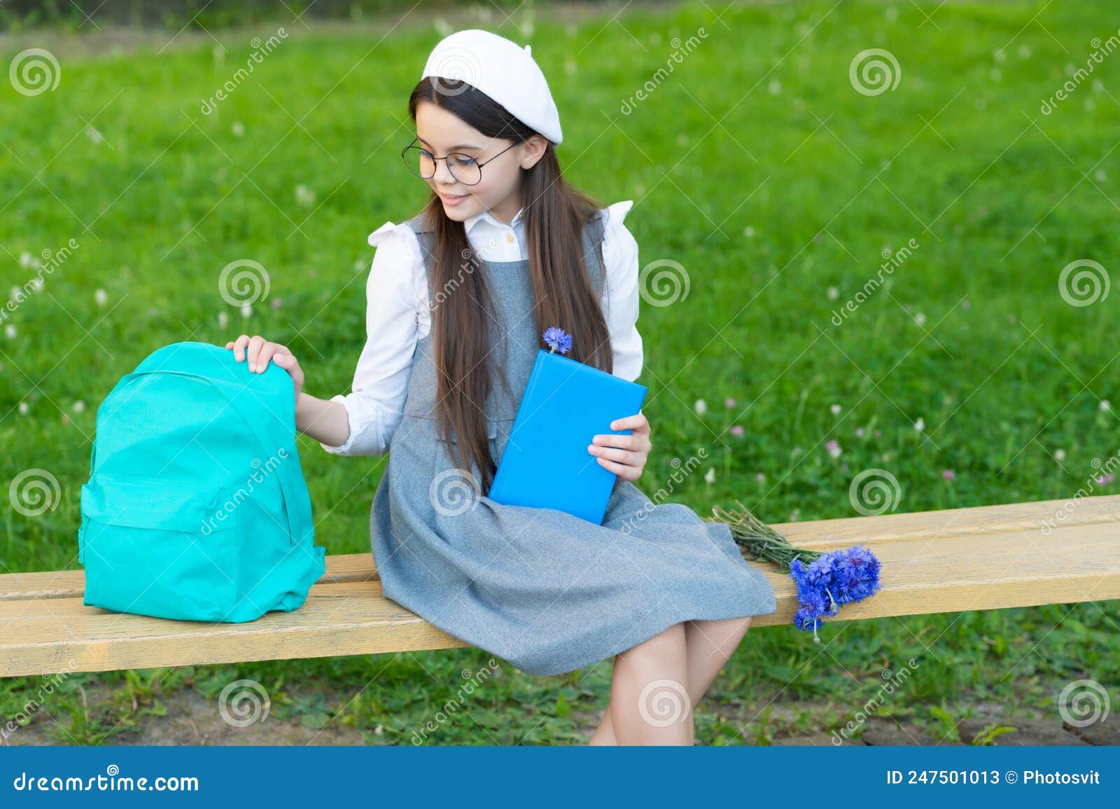 Happy Child in Glasses Relax on Park Bench with Book and Backpack Stock