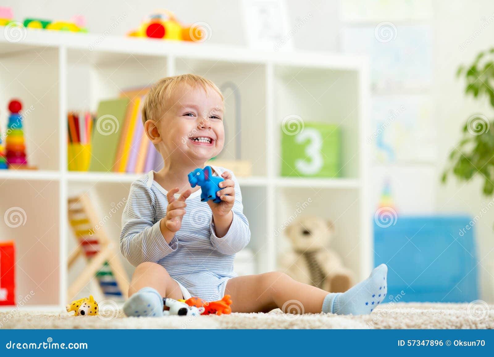 happy child holding elefant toy