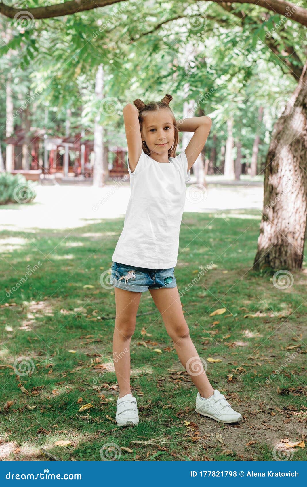 Happy Child Little Girl Standing In A White T Shirt In Park Stock