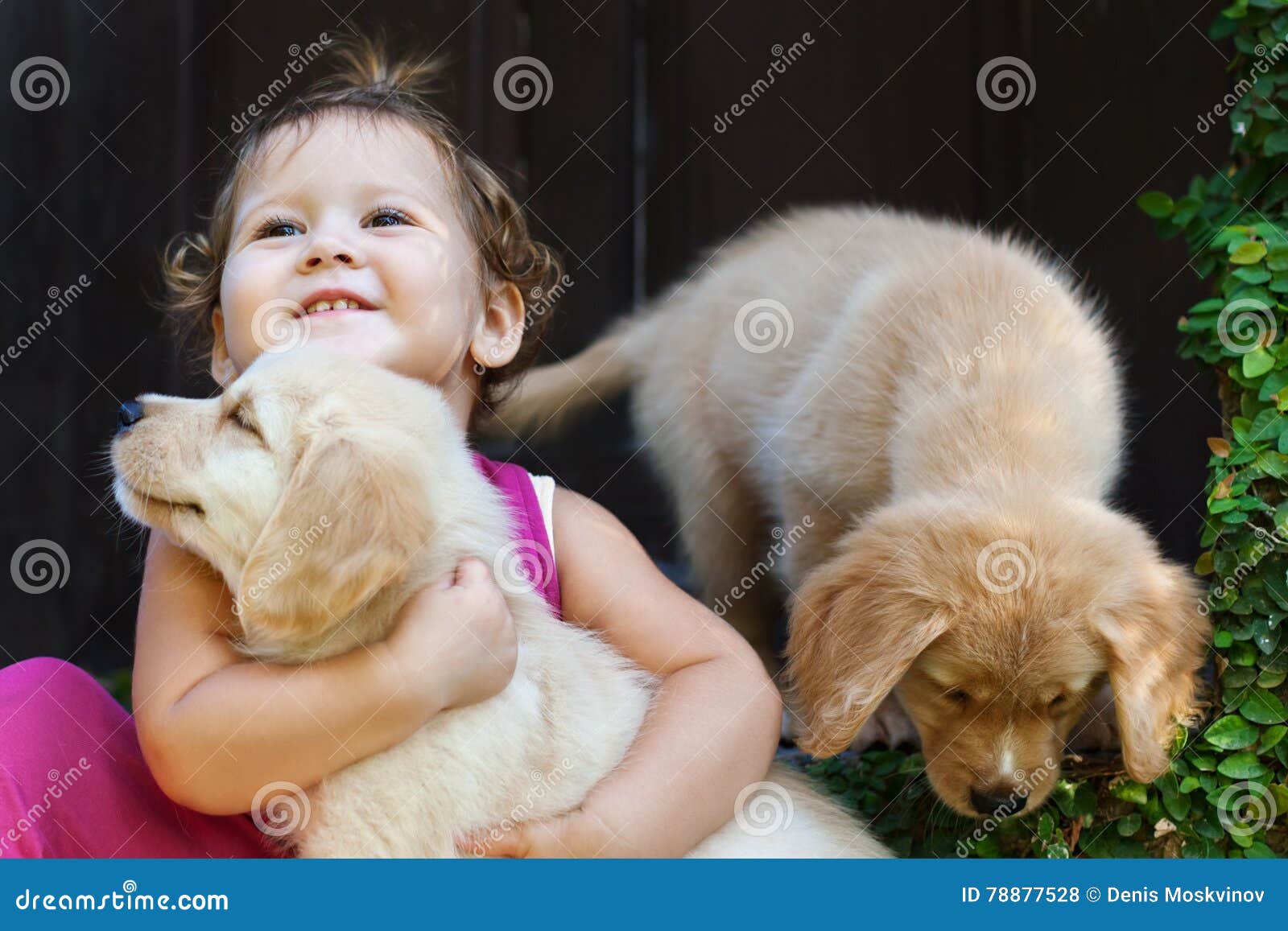 happy child play and hug family pet - labrador puppy
