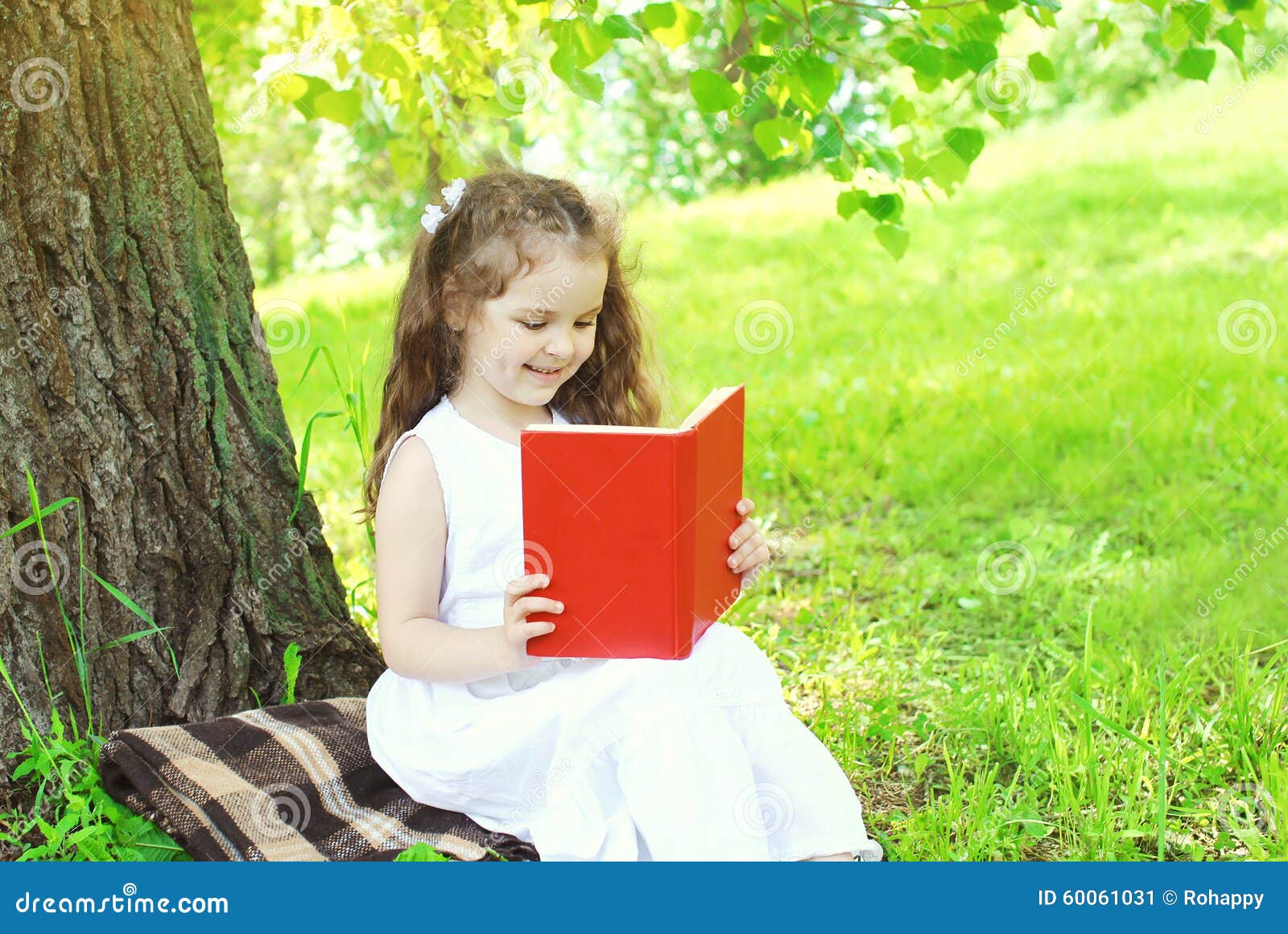 Happy Child Reading Book On Grass In Summer Stock Photo Image 60061031