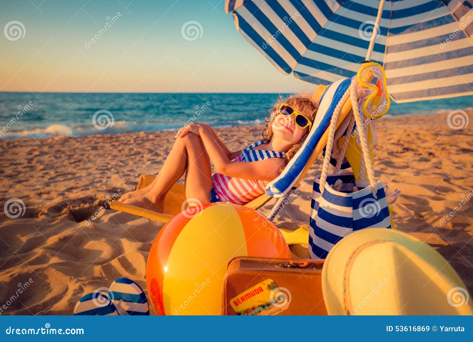 happy child sitting on the sunbed