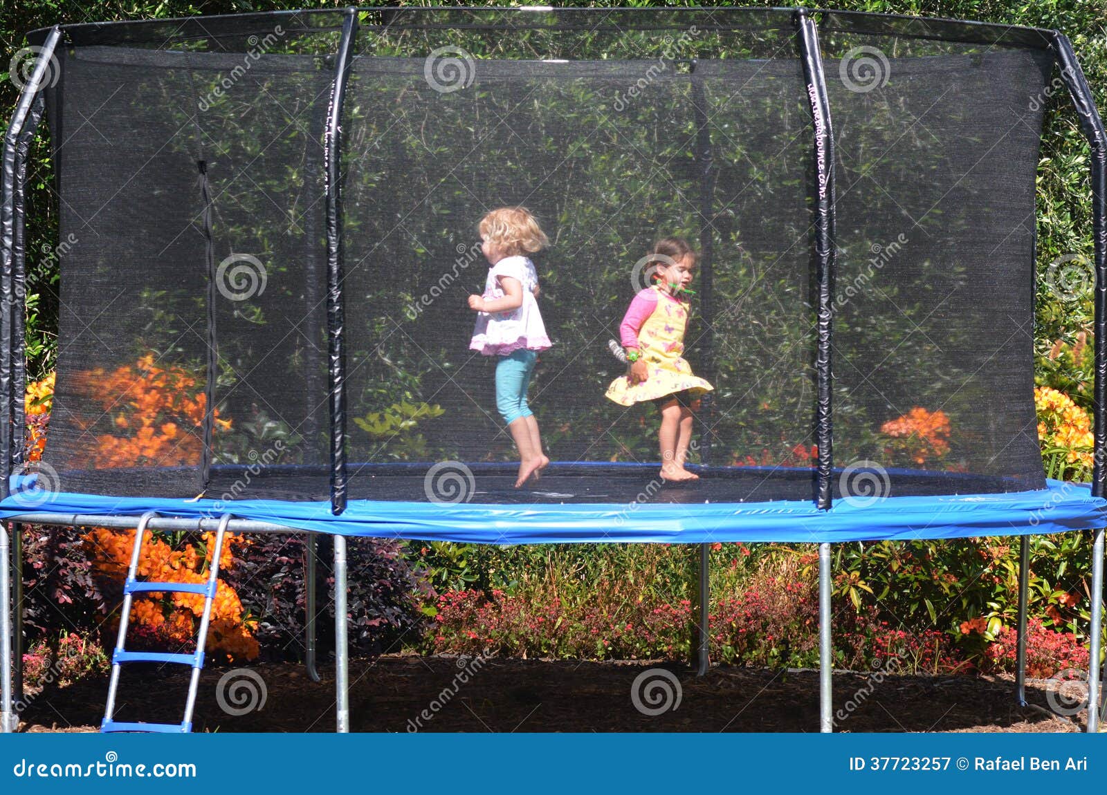 happy children jumping on trampoline