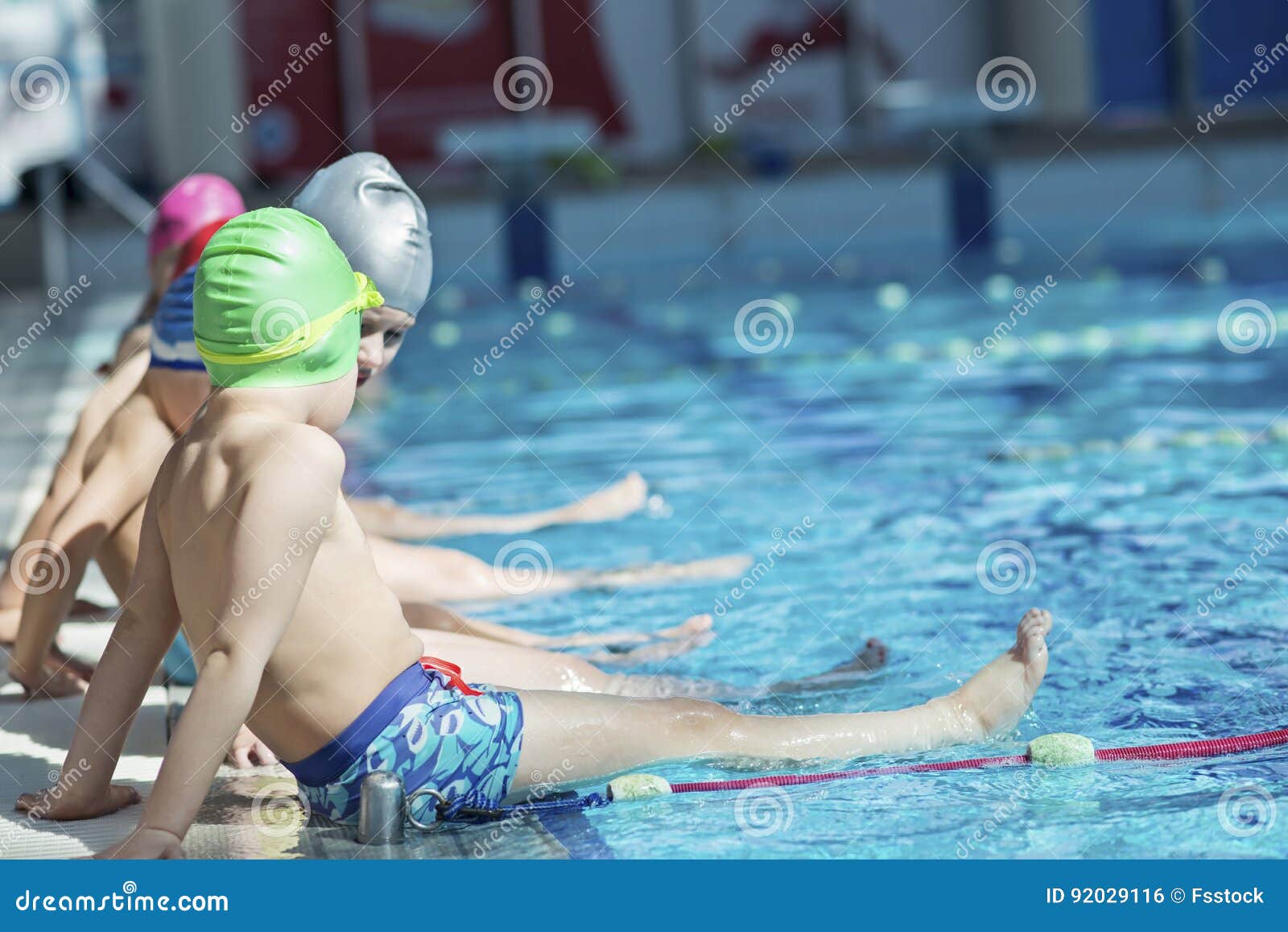 happy children kids group at swimming pool class learning to swim