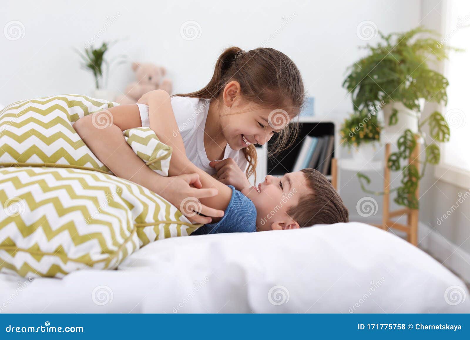 Happy Children Playing with Pillows Stock Photo Image of background