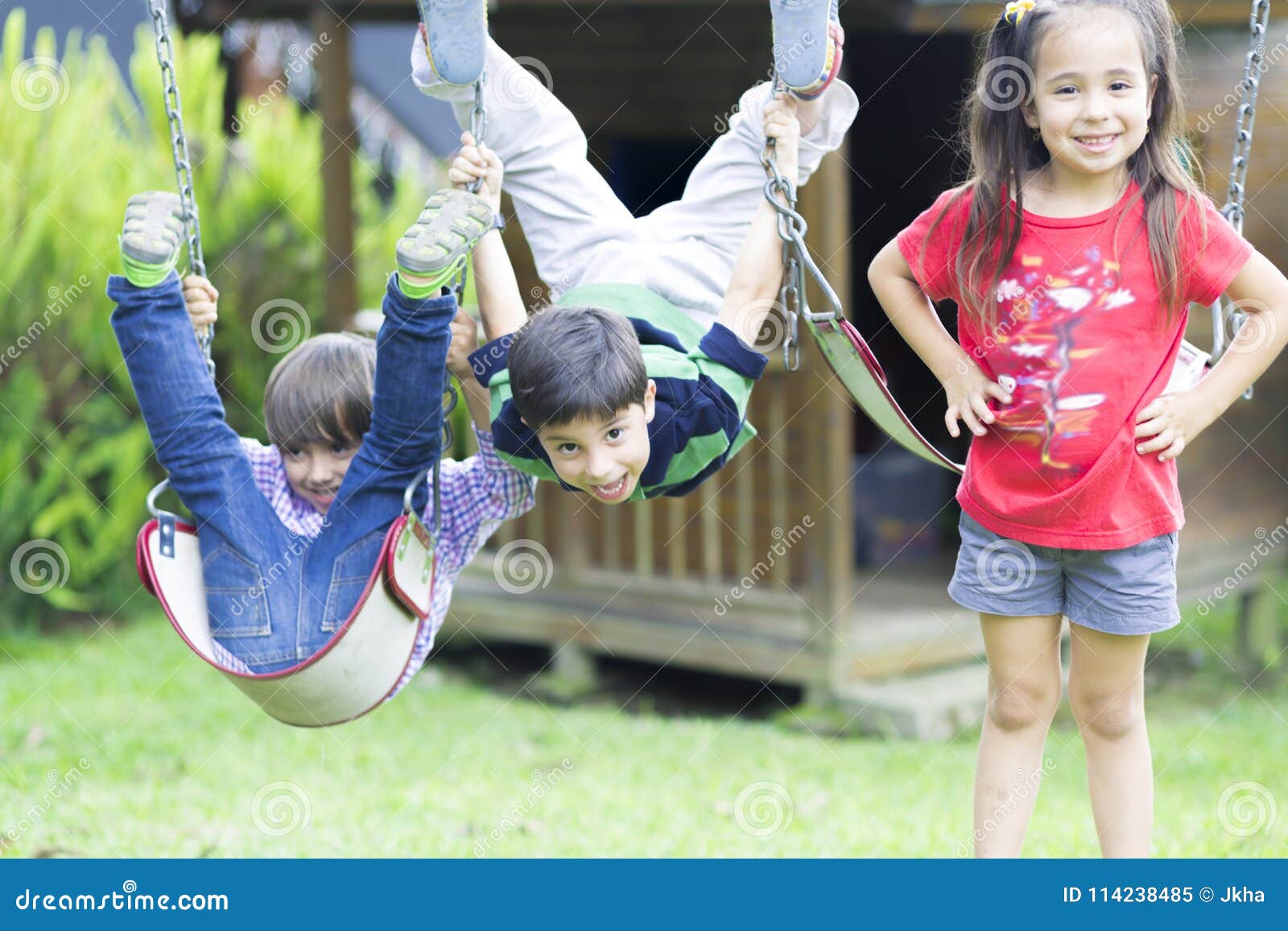 Happy children swinging stock image. Image of girl, friendship - 114238485