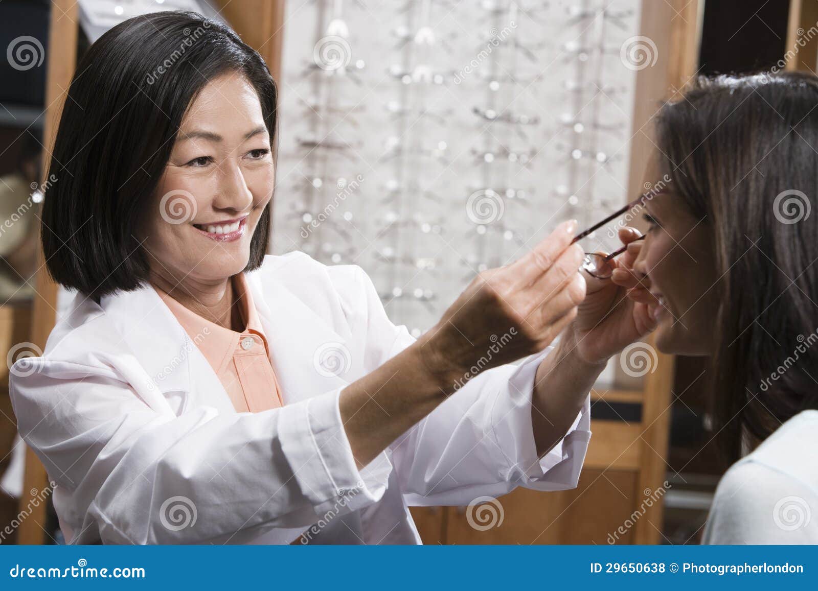 happy chinese optometrist assisting patient