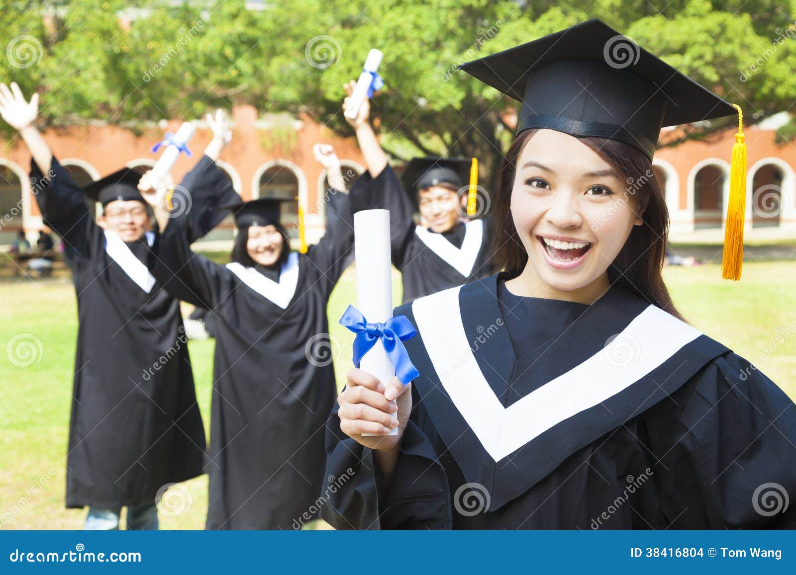 happy college graduate holding a diploma with friends