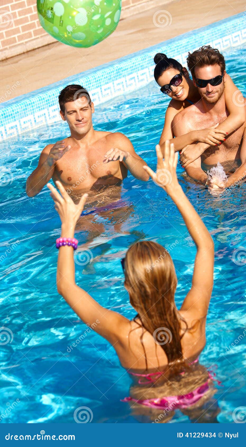 happy companionship having summer fun in pool