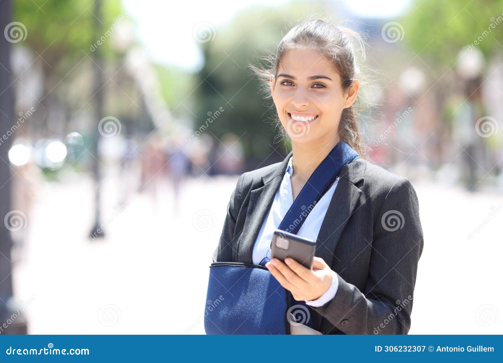 happy convalescent businesswoman holding phone looks at you