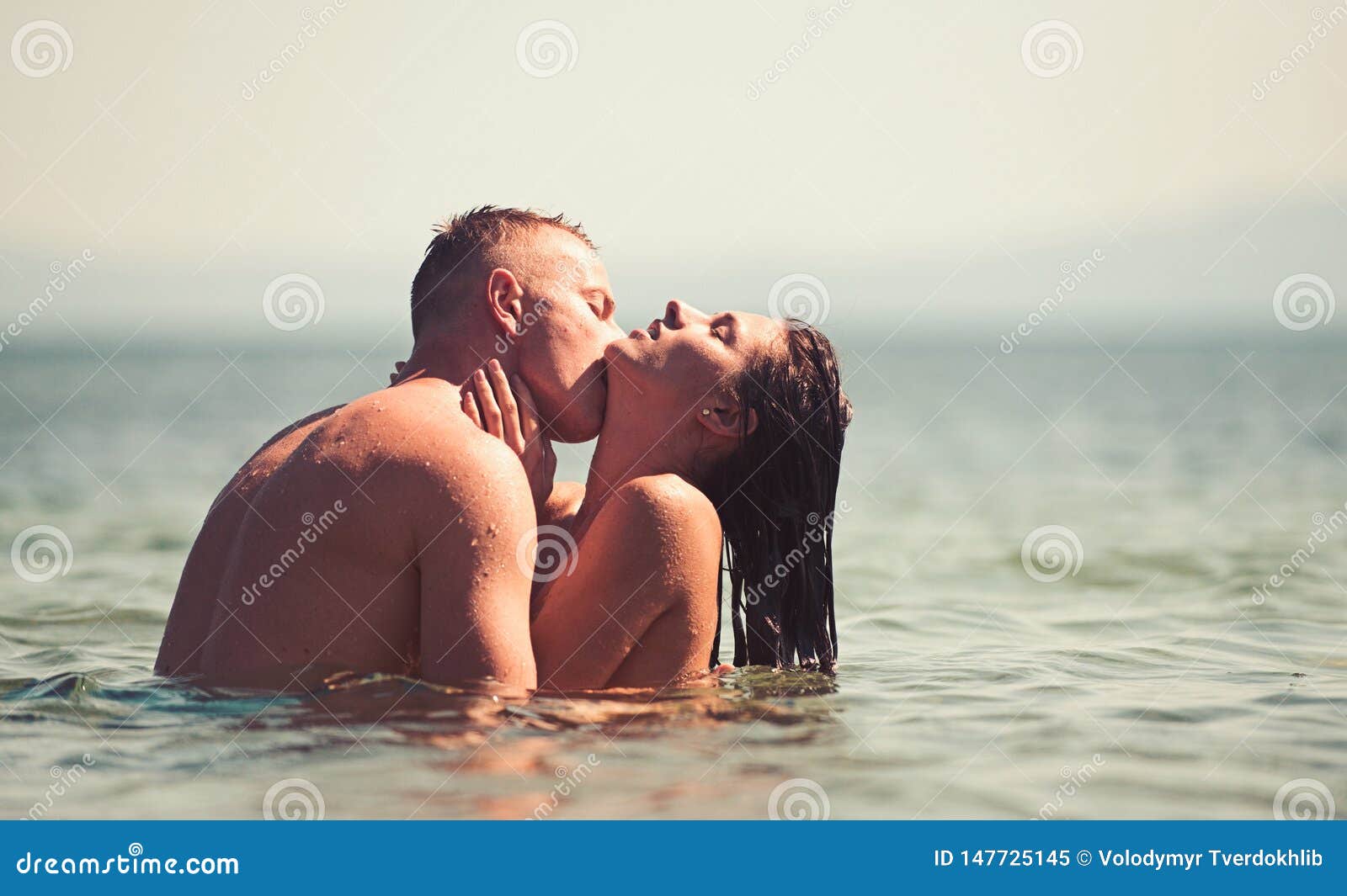 Happy Couple on the Beach Kissing in Water pic pic