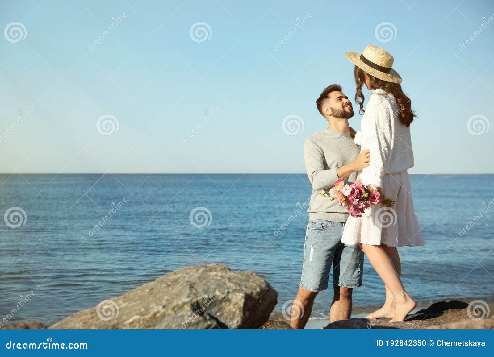 Happy Couple On Beach Near Sea. Honeymoon Trip Stock Photo