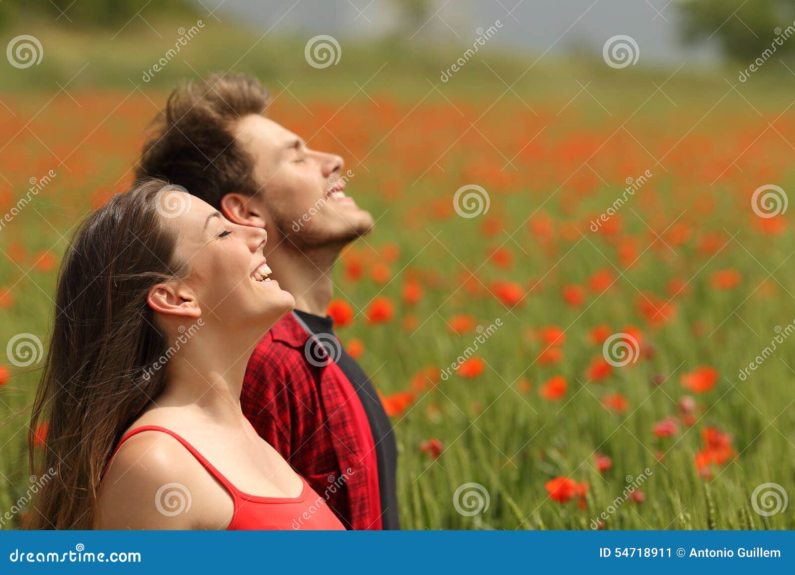 happy couple breathing fresh air in a red field