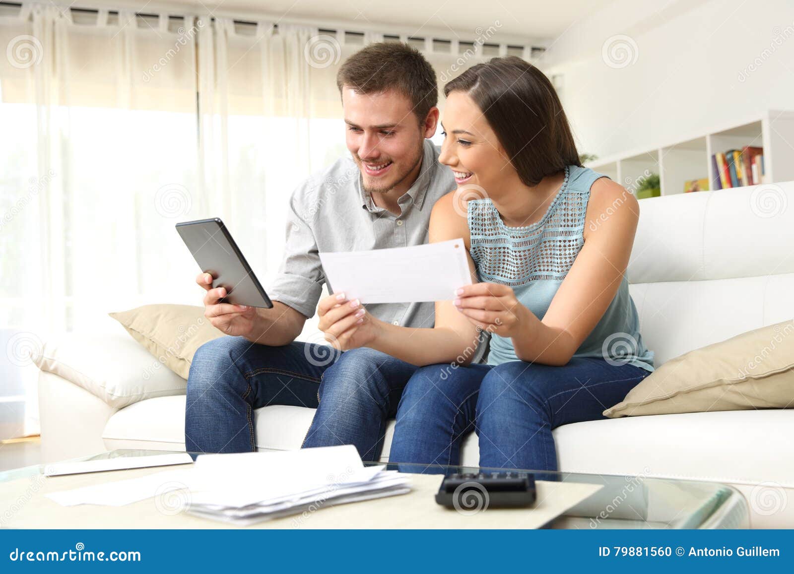 happy couple checking bank account online