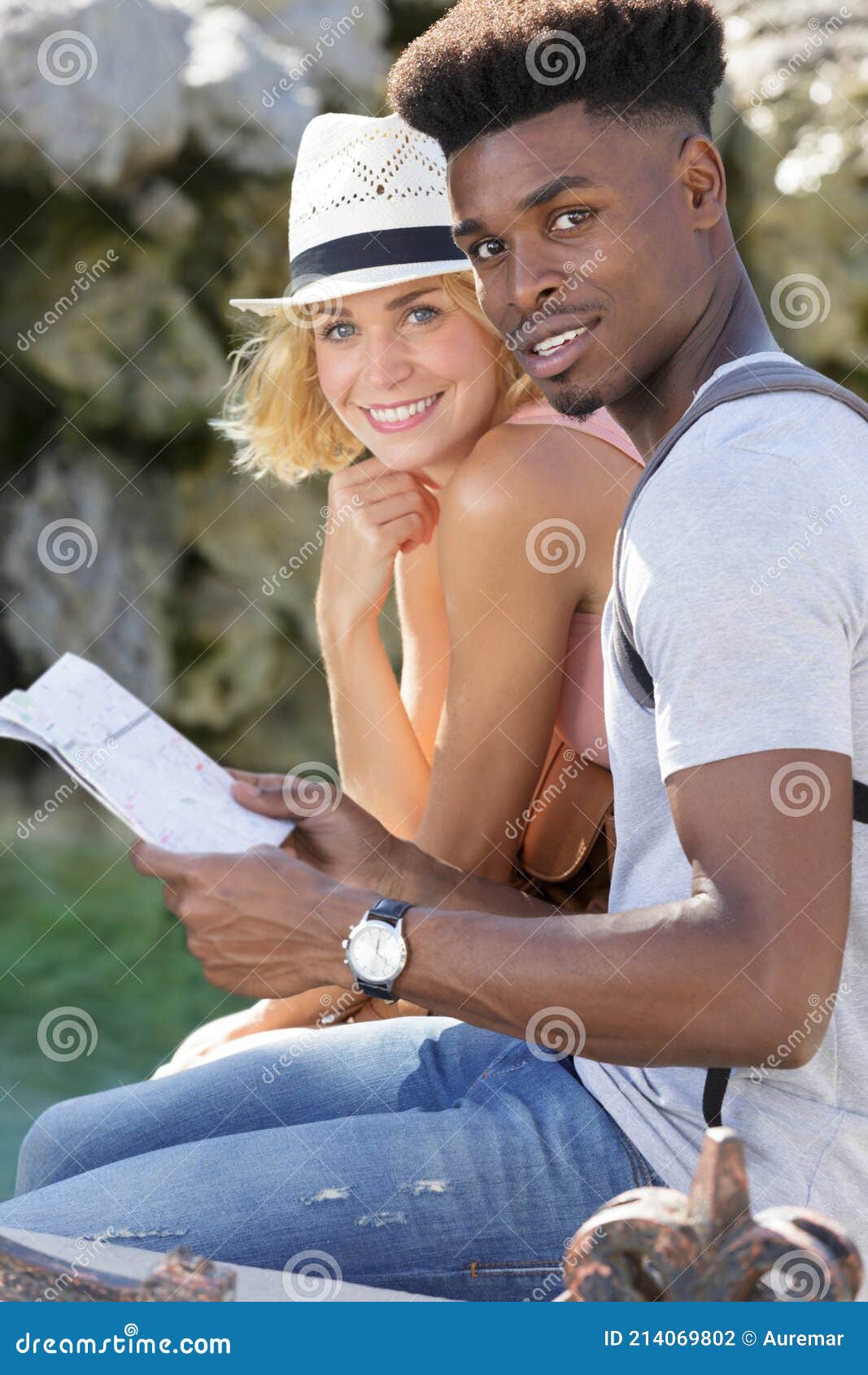 happy couple checking map outdoors