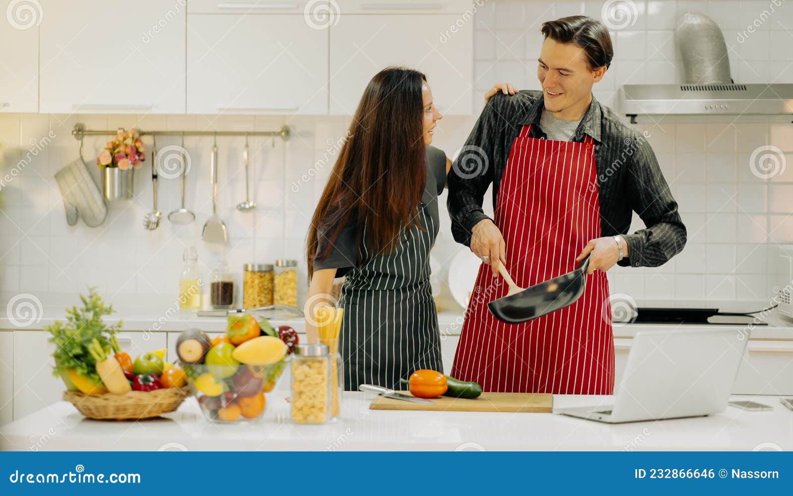 Happy Couple Cooking Meal Together in Home Kitchen. Young Husband