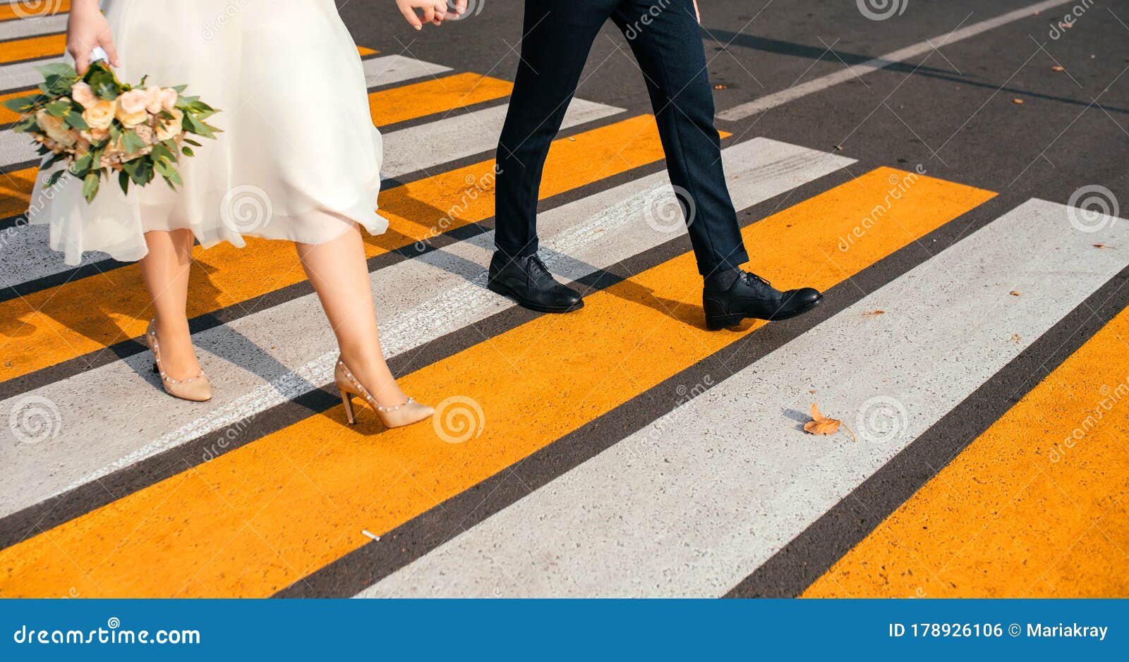 Caucasian Couple Holding Hands Crossing City Intersection Stock Photo