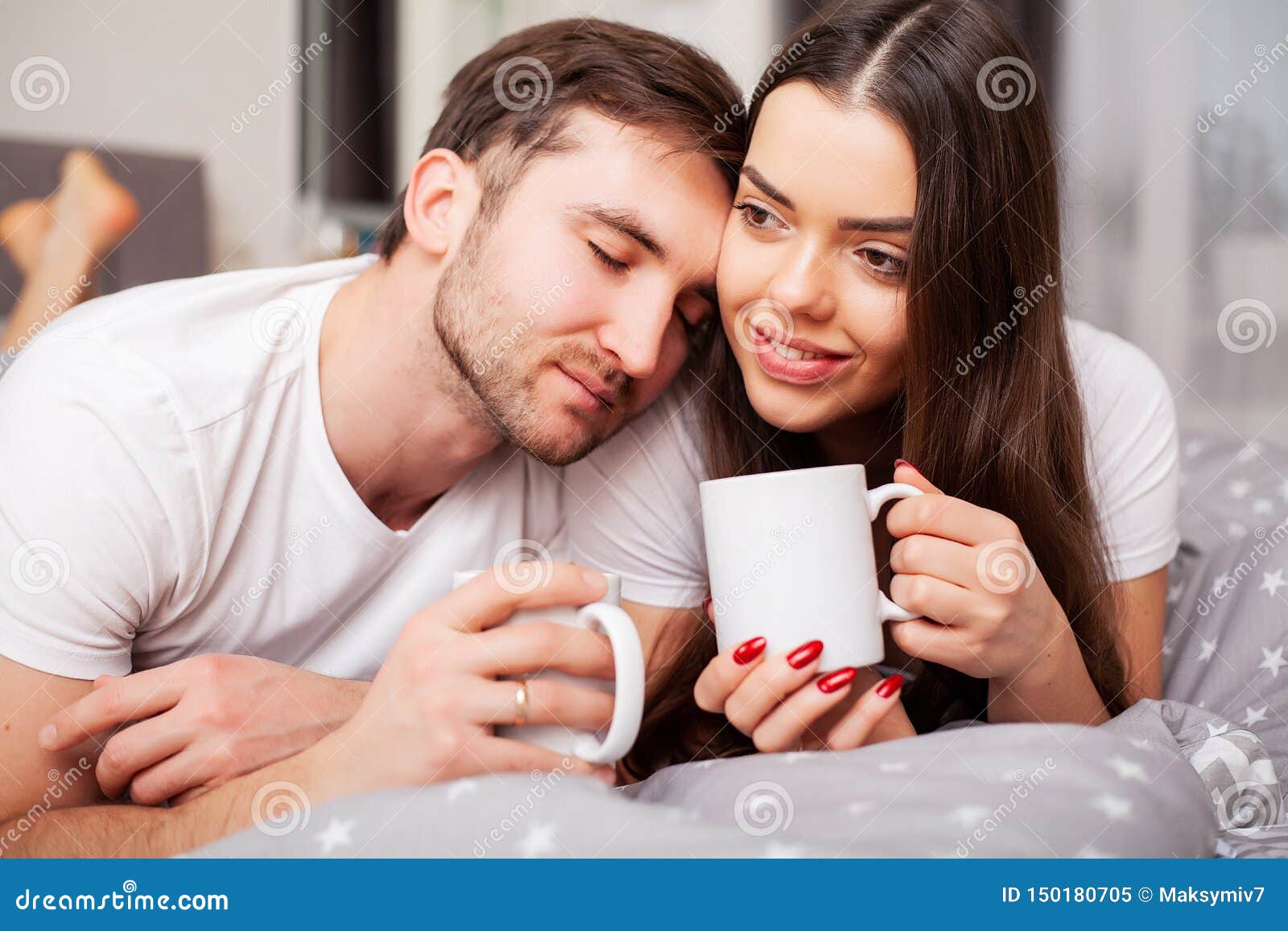 Happy Couple Having Fun In BedYoung Couple In Bedroom Enjoying Each