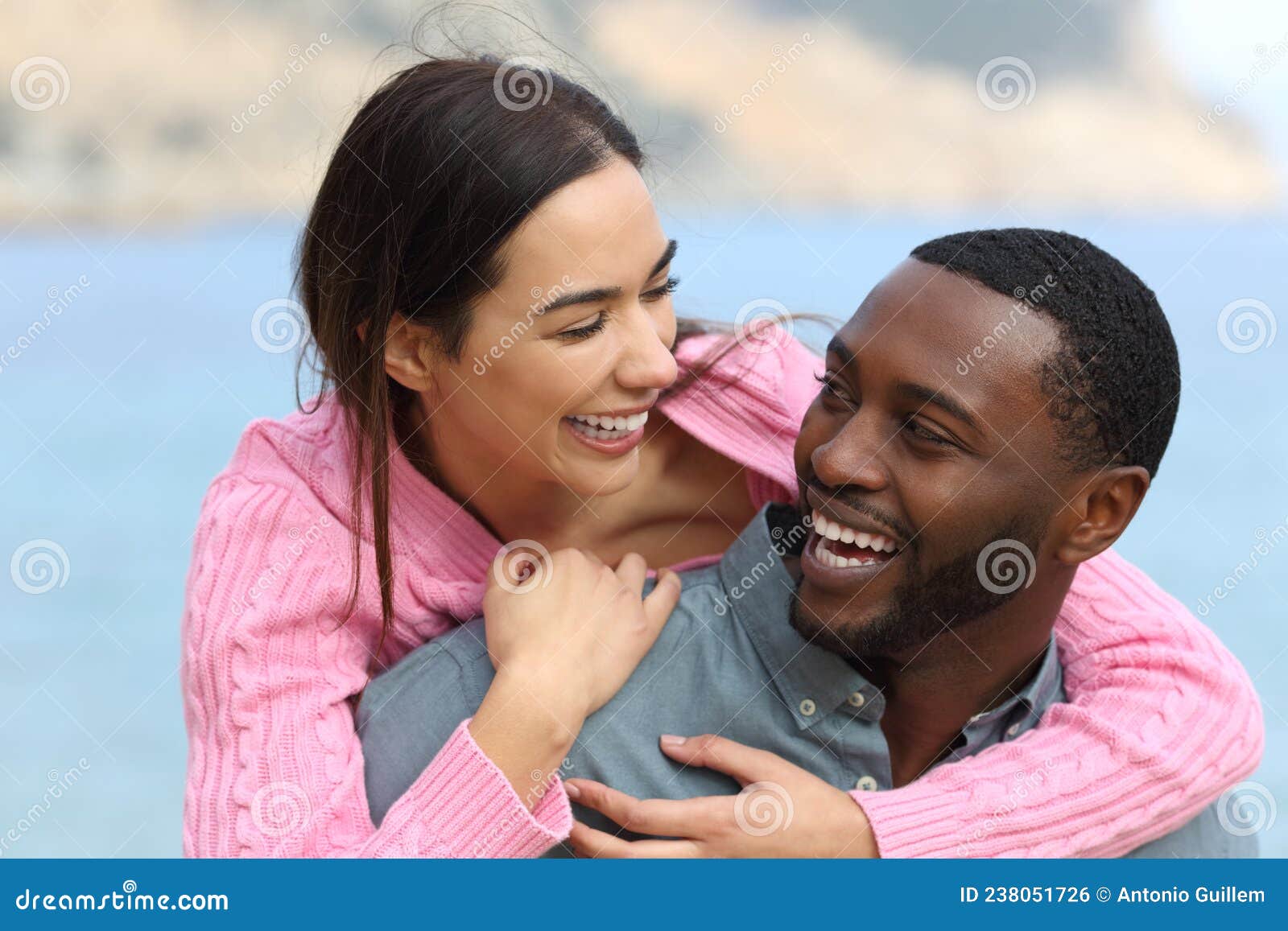 happy couple joking and laughing on the beach