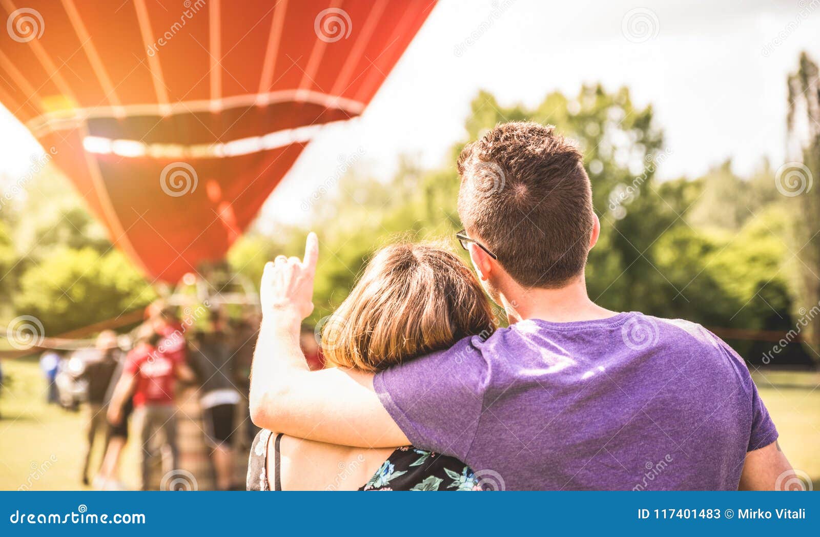 happy couple in love on honeymoon excursion waiting for hot air