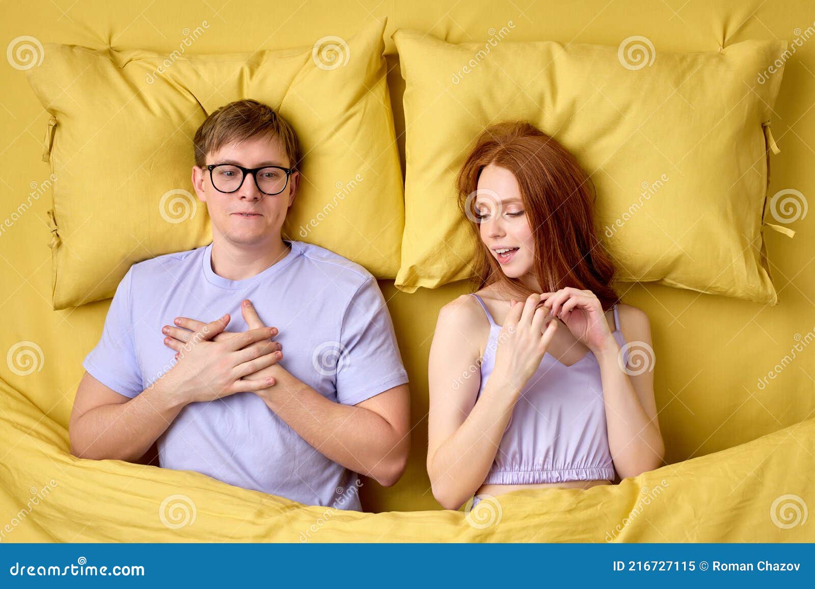 Happy Couple Lying in Bed Under Duvet after First Sex Experience, Man is Surprised by Skills of Female in Bed Stock Image