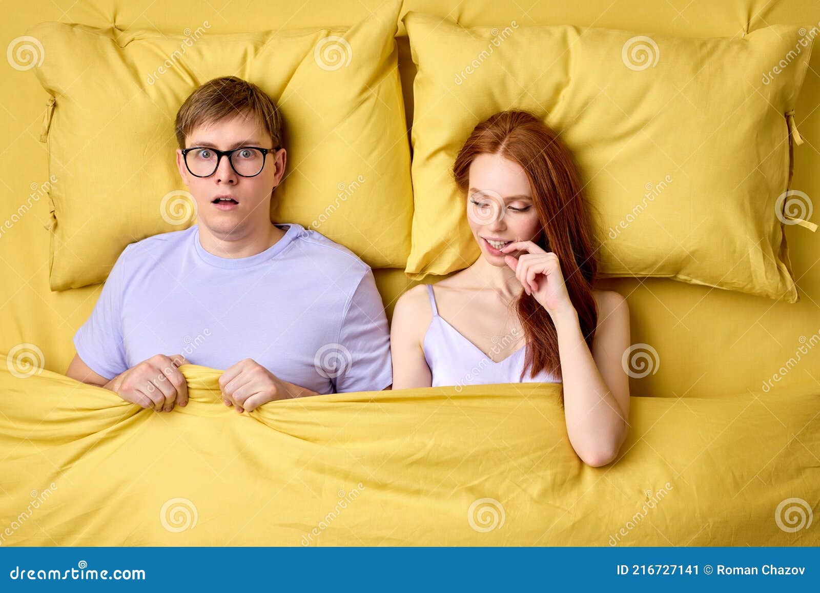 Happy Couple Lying in Bed Under Duvet after First Sex Experience, Man is Surprised by Skills of Female in Bed Stock Image