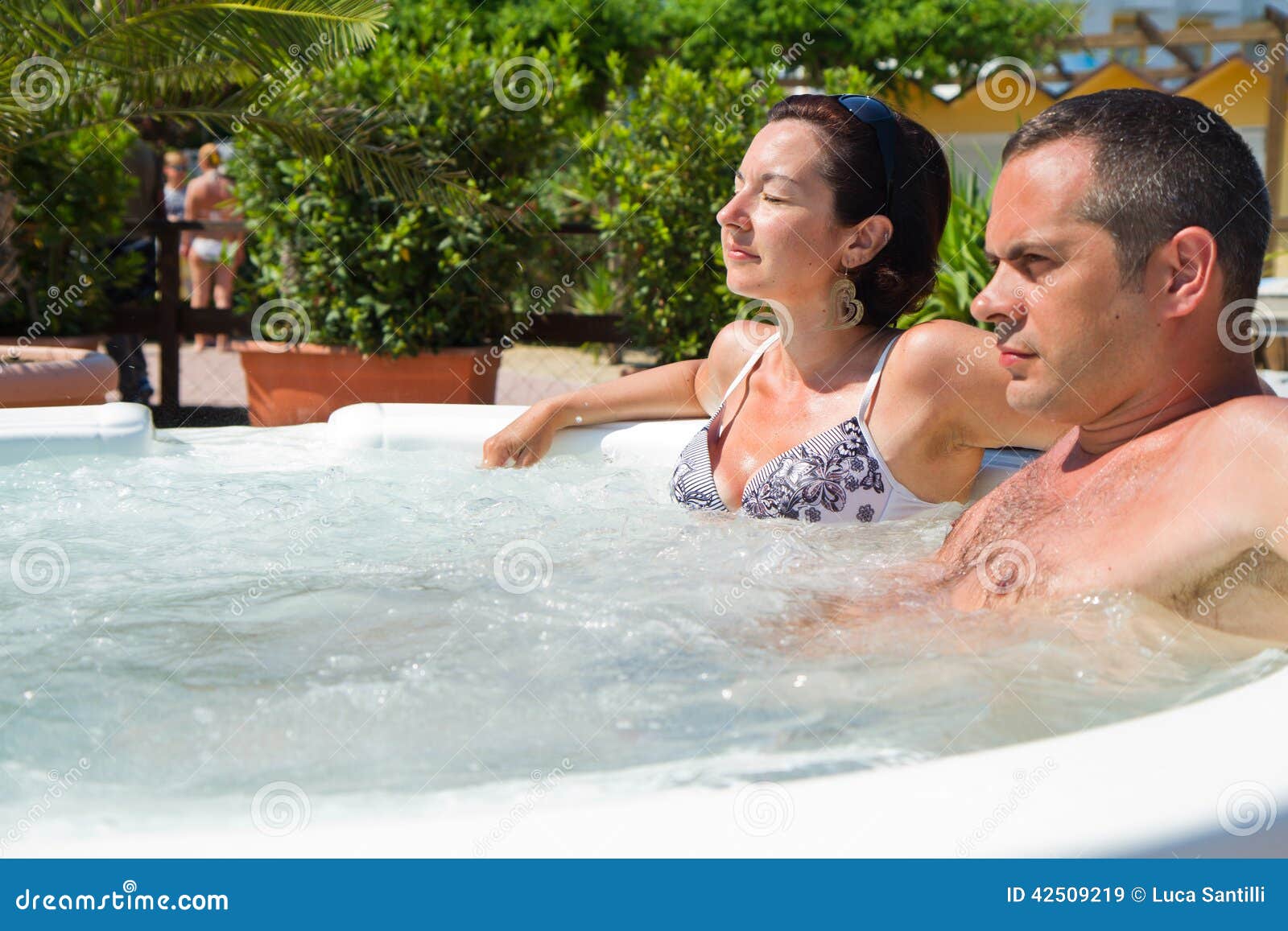 Happy Couple Relaxing In Hot Tub Vacation Stock Image