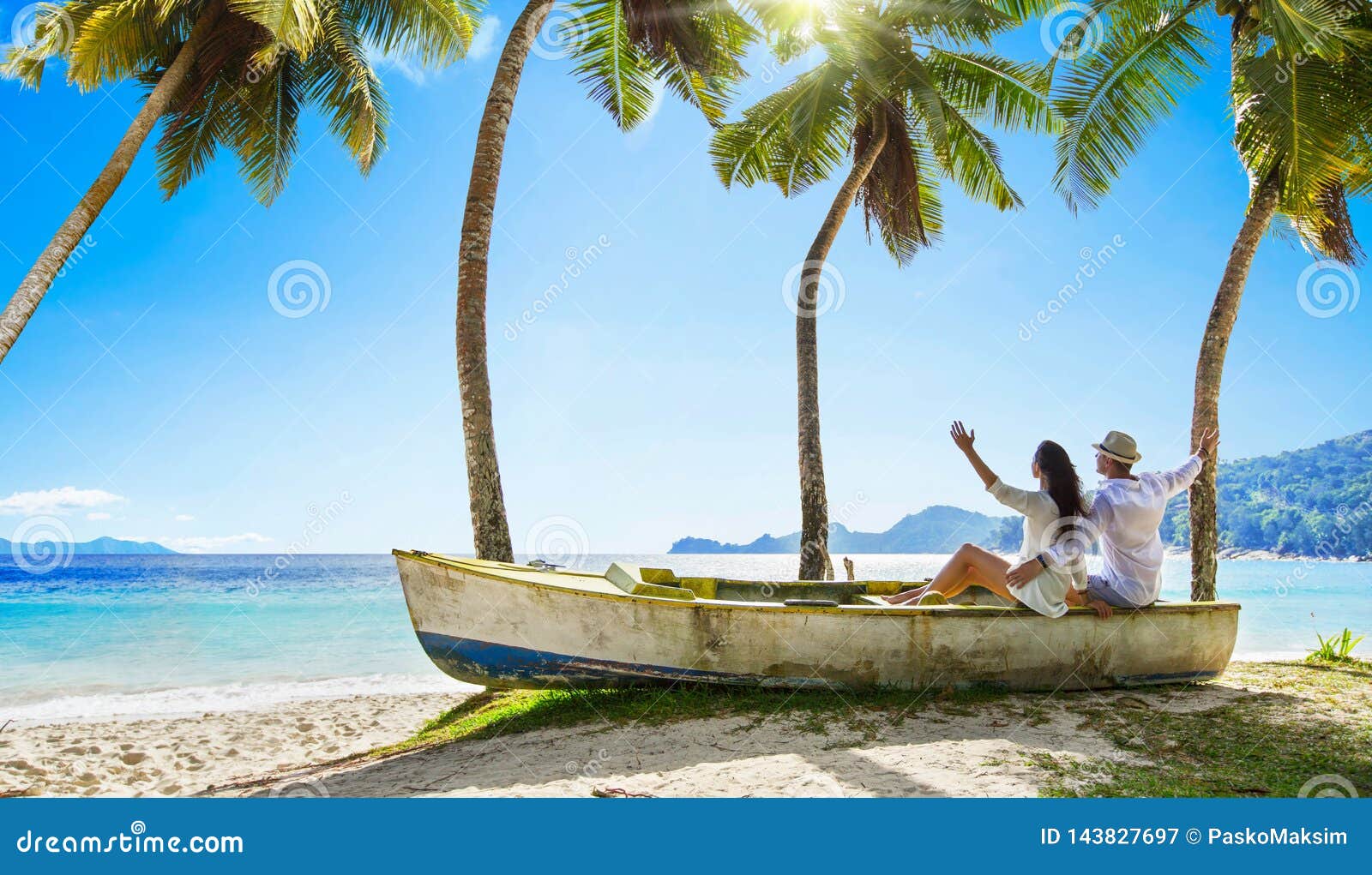 happy couple relaxing on the ocean. seychelles island