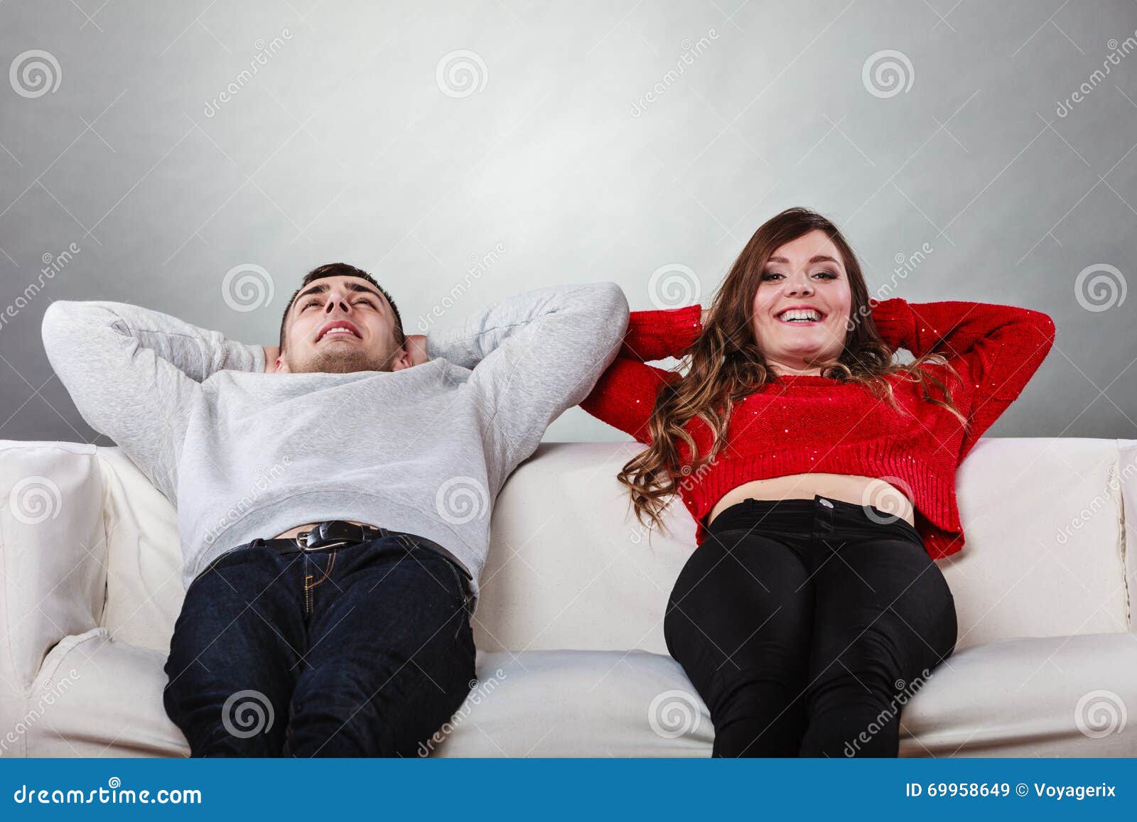 happy couple relaxing resting on couch at home.
