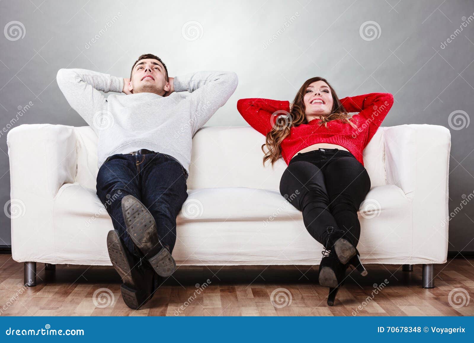 happy couple relaxing resting on couch at home.