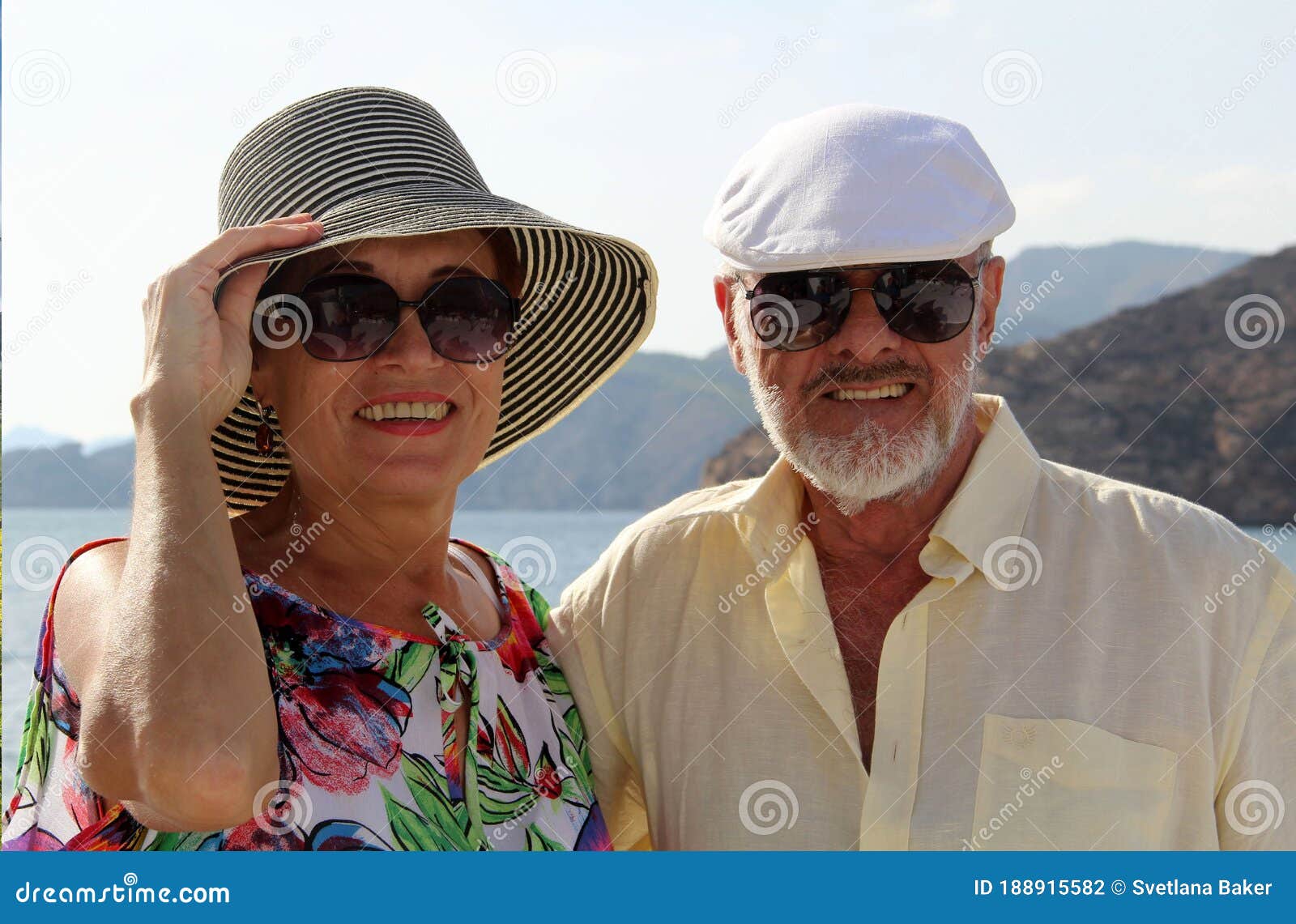 happy couple of seniors on the tourist boat  smiling, enjoying trip on the mediterranian sea