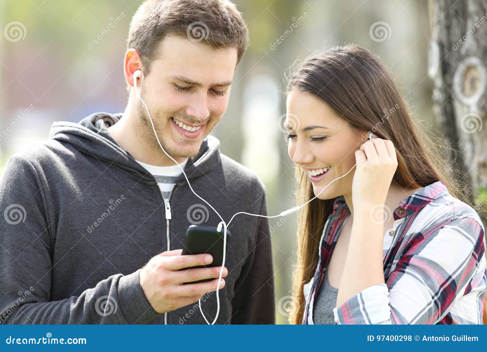 Happy Couple Of Teenagers Sharing Music Stock Photo Image Of
