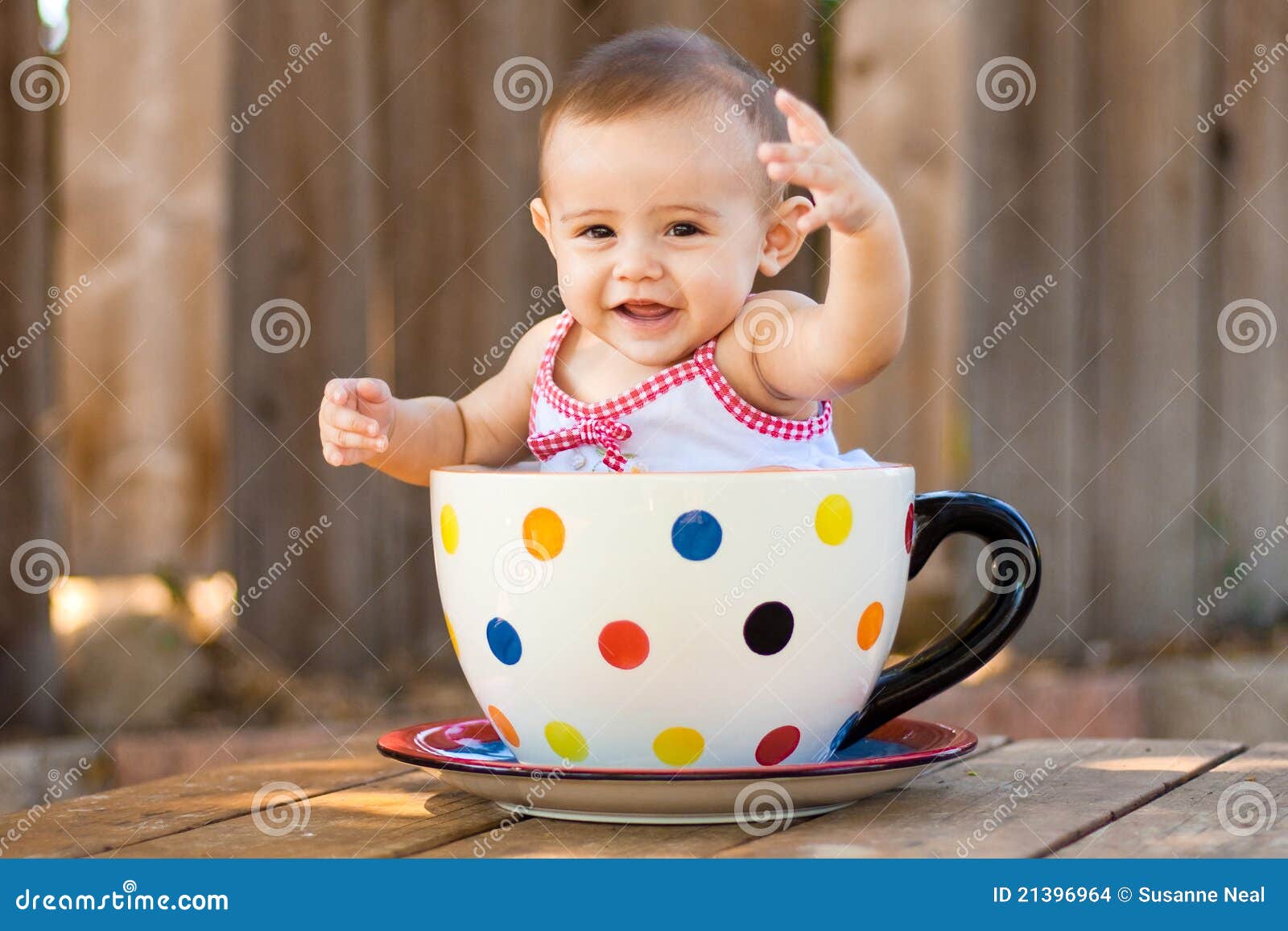 happy and cute baby girl in giant teacup