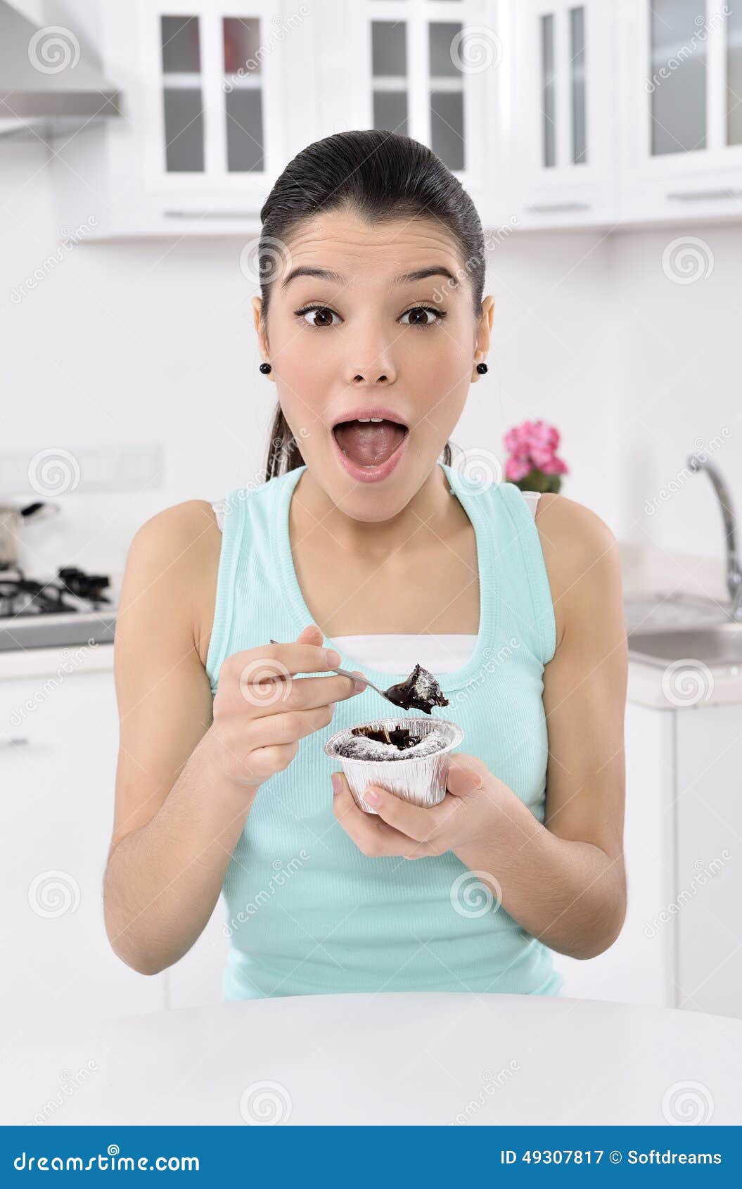 happy cute young woman eats a cake
