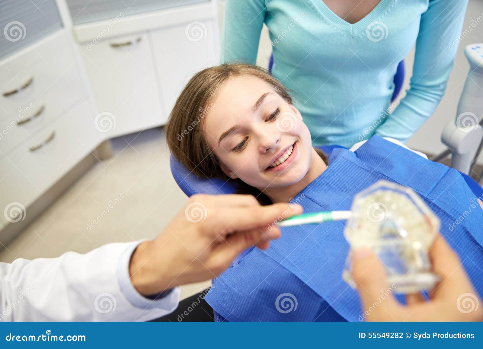 Happy Showing Toothbrush Happy Dentist Showing Toothbrush To Patient Stock