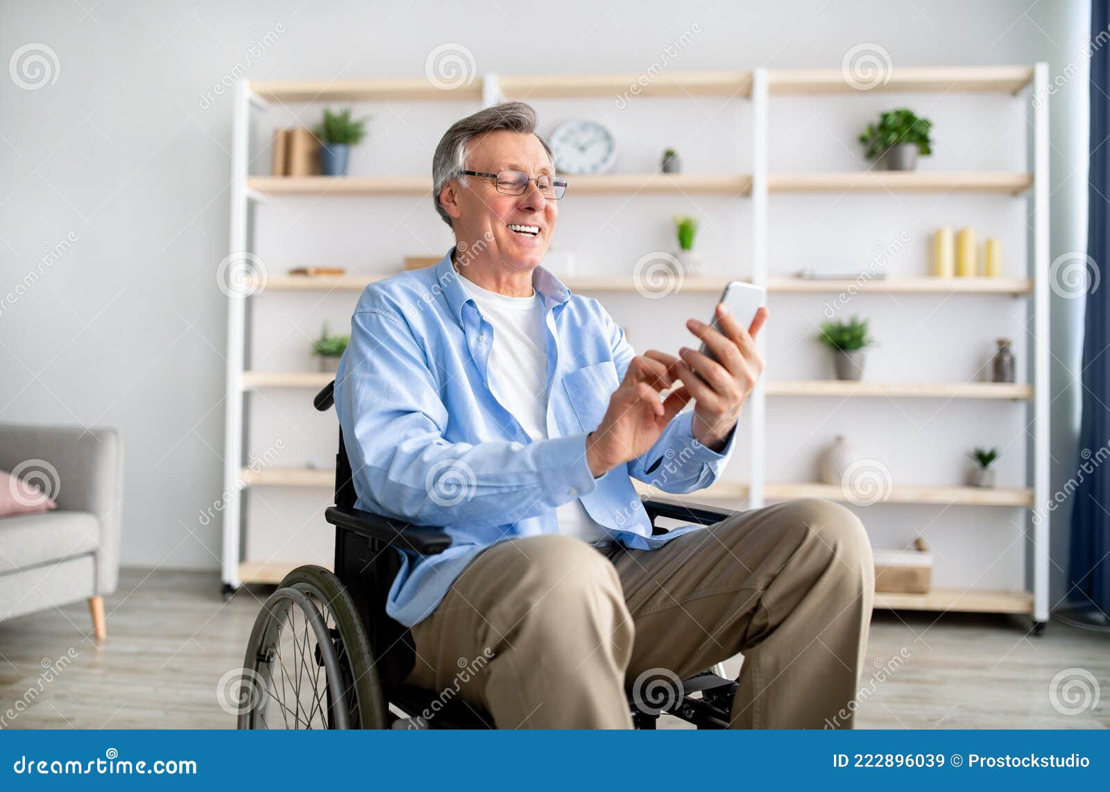 happy-disabled-older-man-wheelchair-using-cellphone-browsing-web-watching-movie-retirement-home-handicapped-senior-male-222896039.jpg