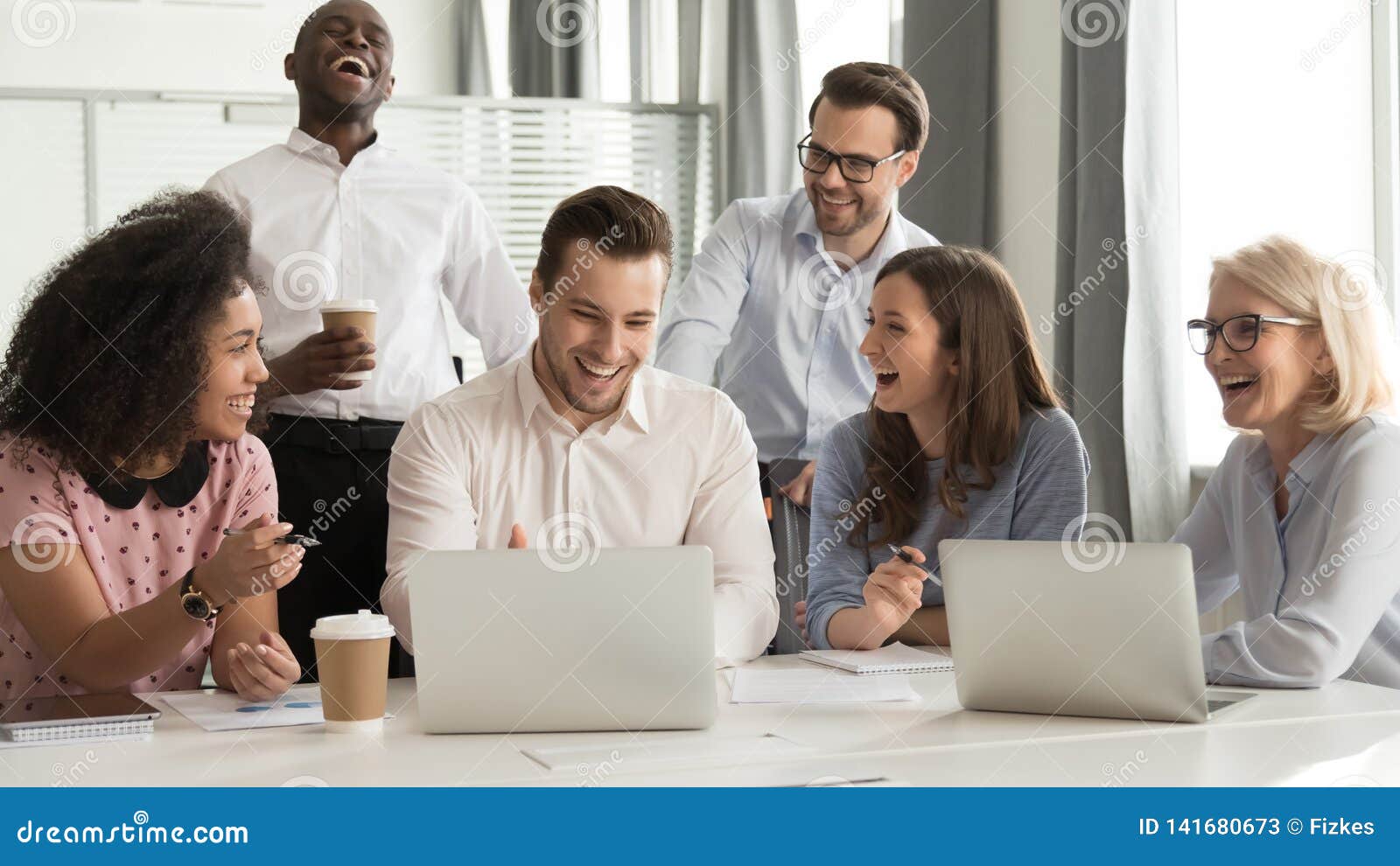 happy diverse office workers team laughing together at group meeting