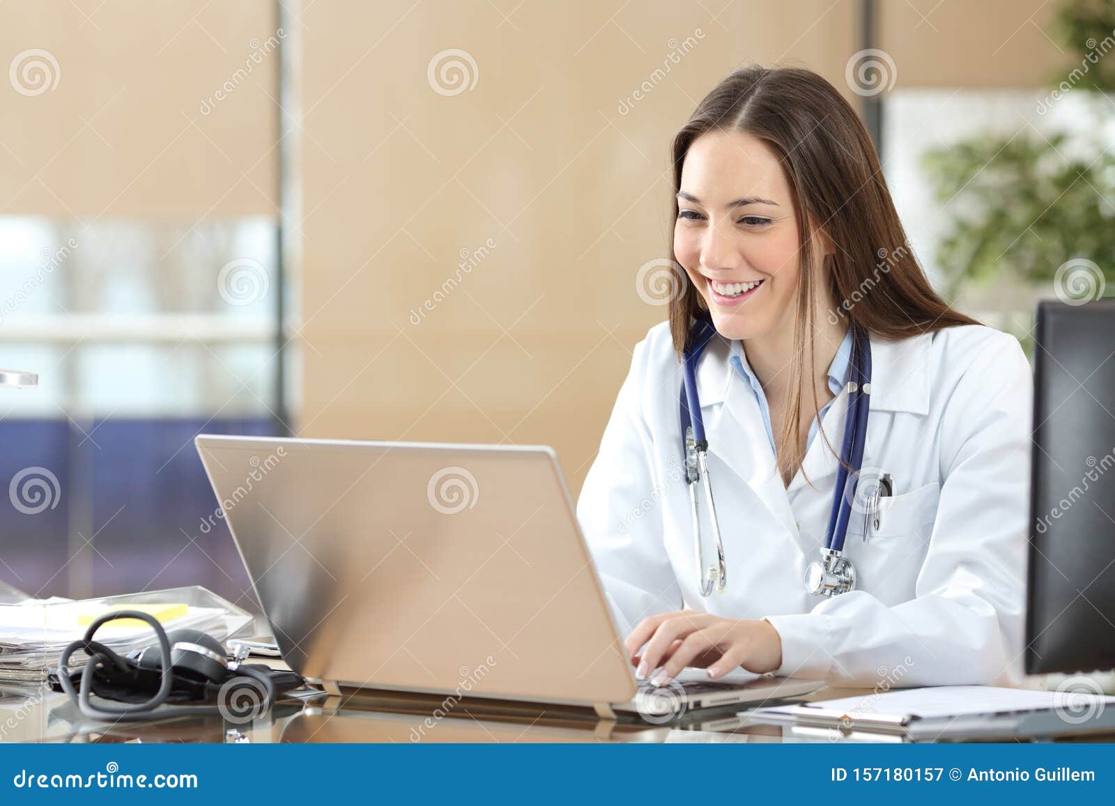 happy doctor using a laptop at consultation