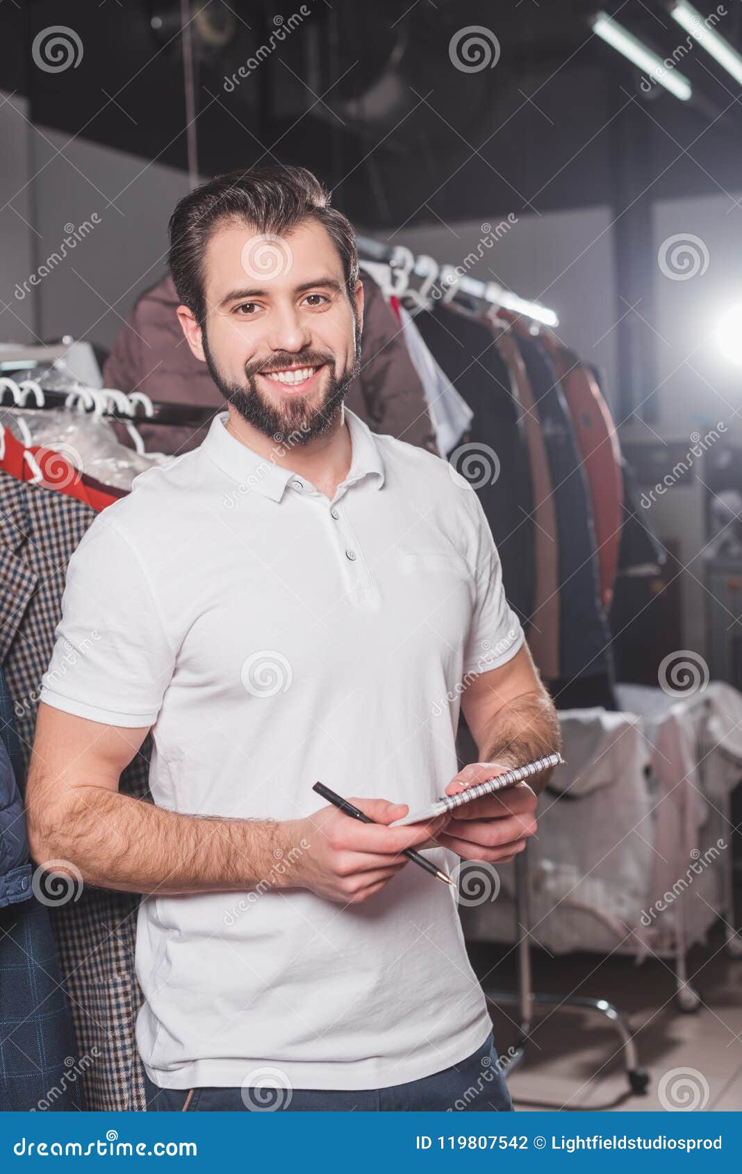 Happy Dry Cleaning Worker with Notepad Stock Photo Image of hanging