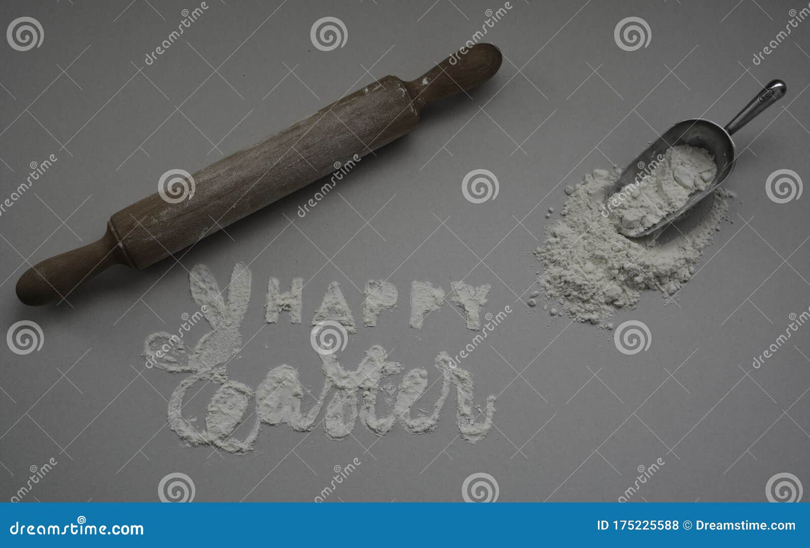 happy easter card  in background. handmade lettering with flour with easter logo first letter in the  of a rabbit.