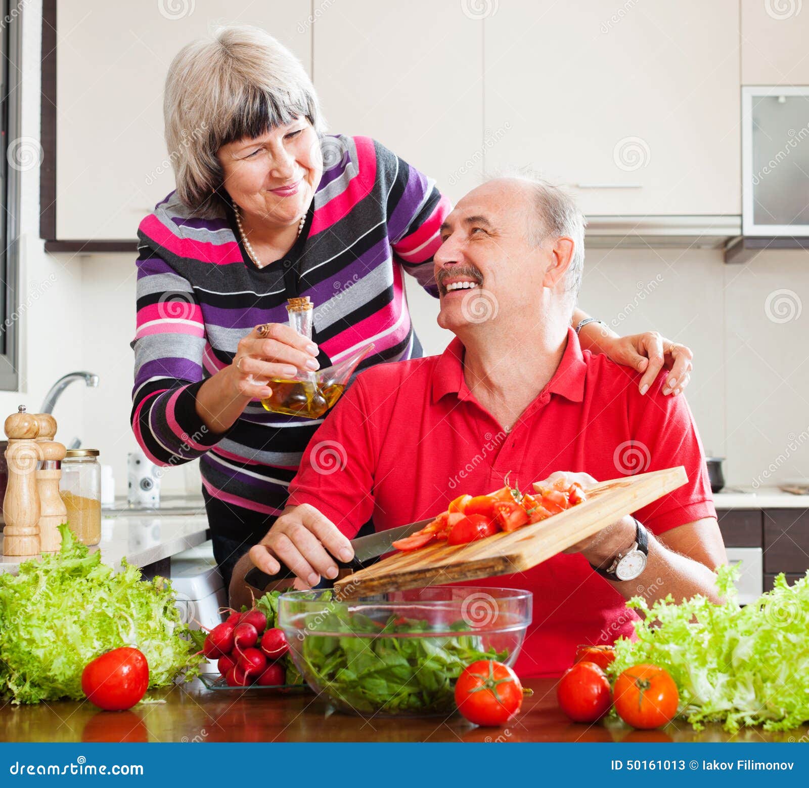 Happy Elderly Couple Cooking with Tomatoes Stock Image Image of