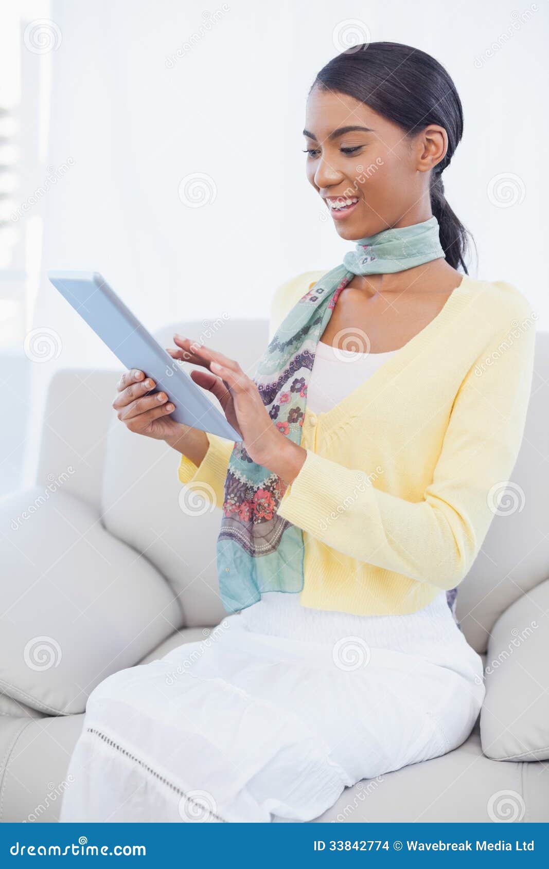 Happy Elegant Woman Sitting on Sofa Using Her Tablet Stock Photo ...