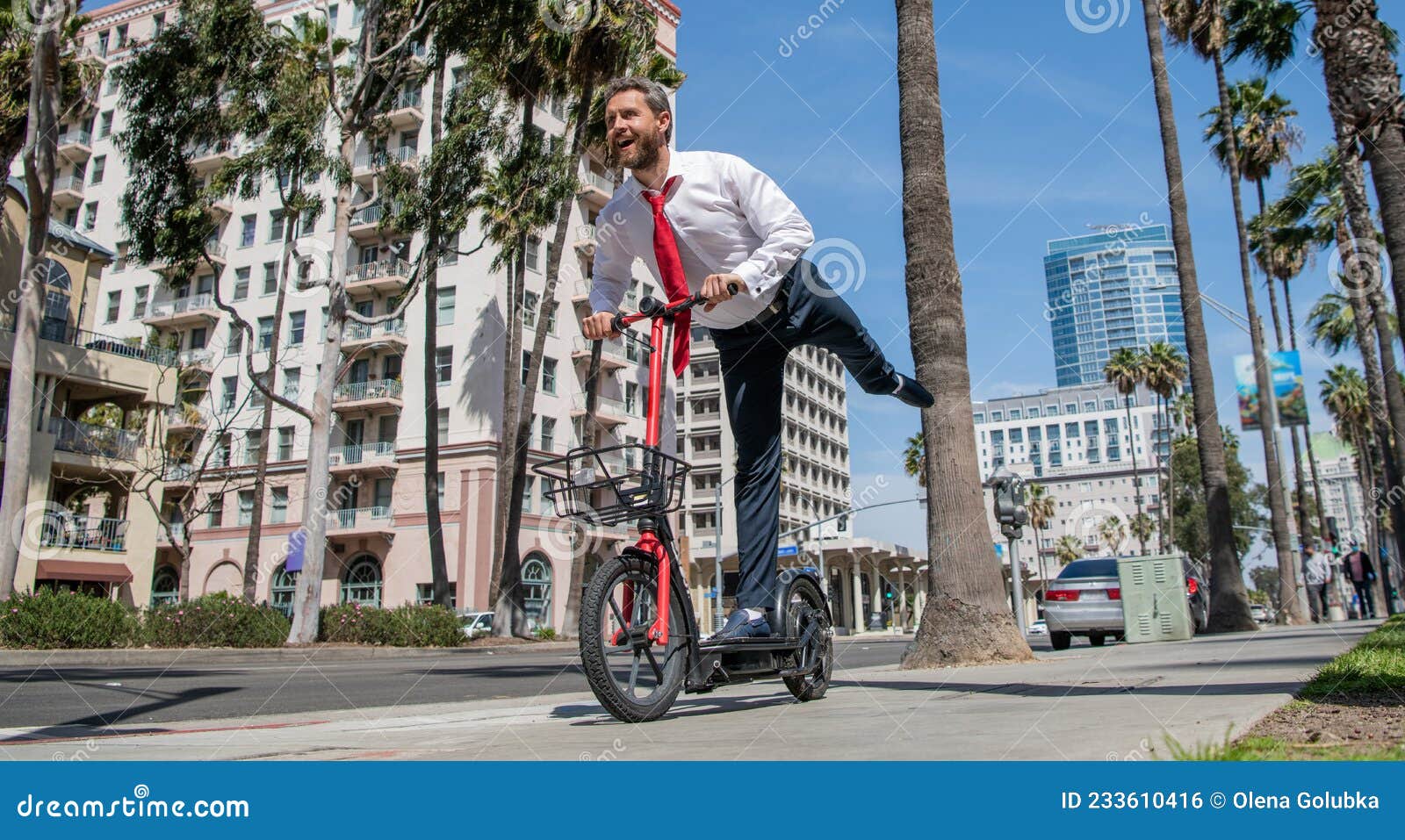 happy employer in formalwear have fun riding escooter on sidewalk, recreation