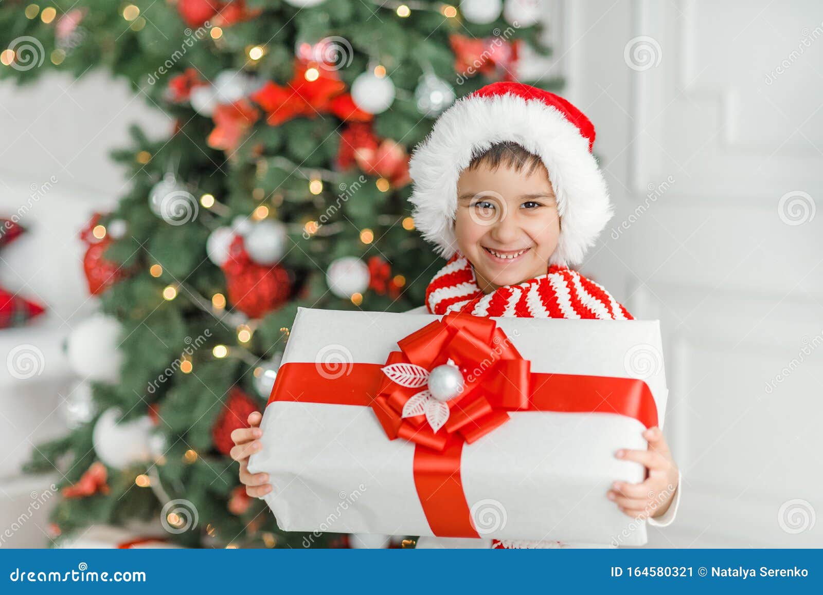 happy-excited-child-holding-christmas-gift-box-happy-excited-child-holding-christmas-gift-box-boy-giving-christmas-present-164580321.jpg