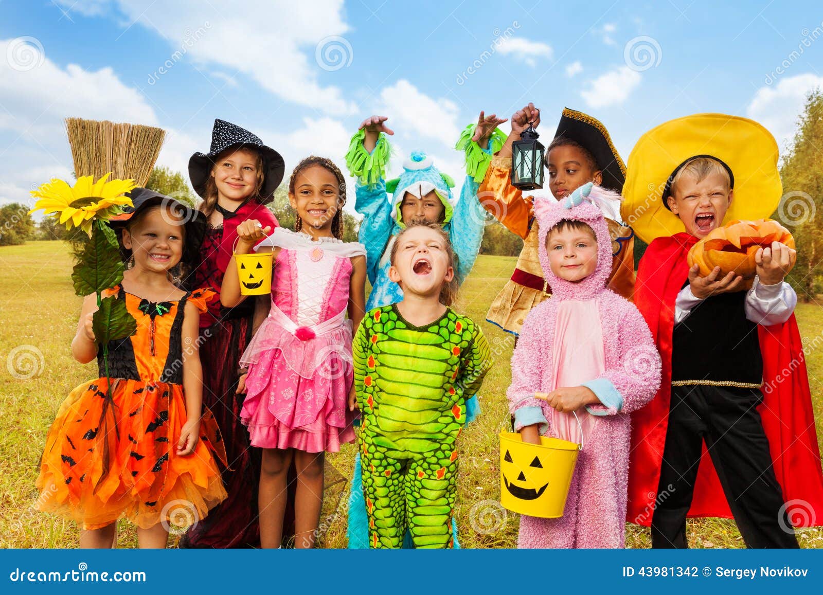 happy excited kids in halloween costumes