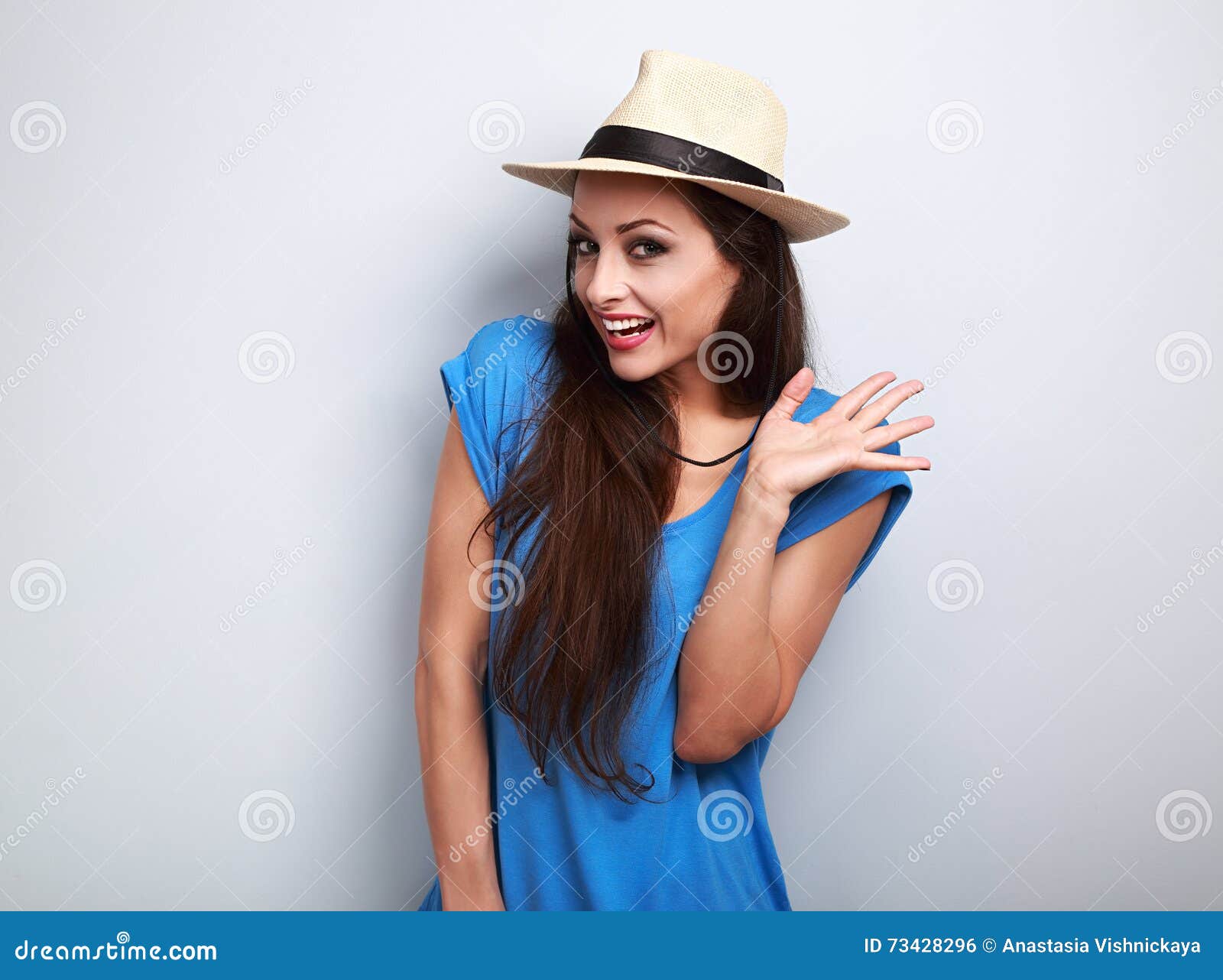 Happy Excited Young Woman in Blue Top and Summer Hat Looking on Stock ...