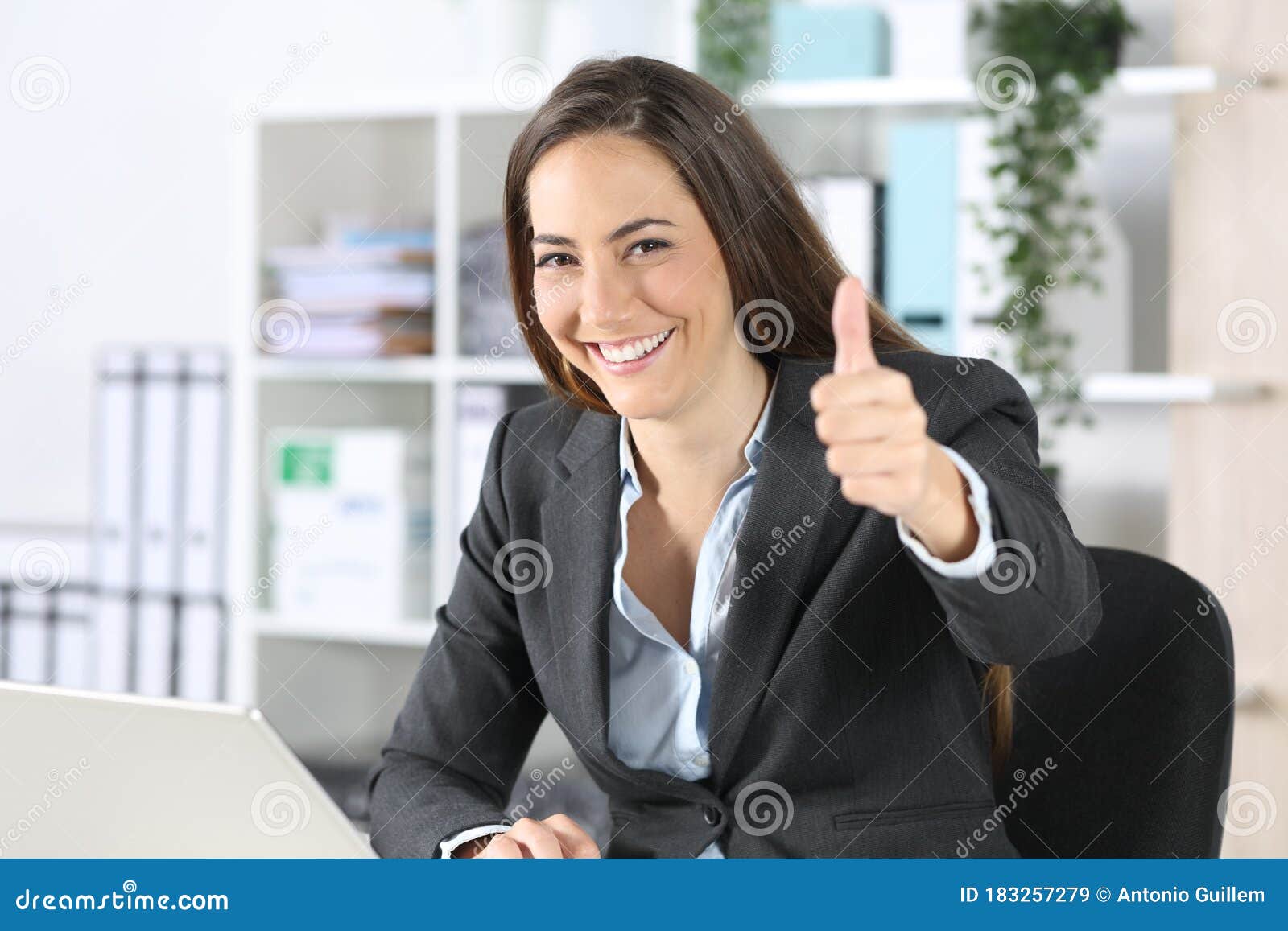 happy executive gesturing thumbs up at office