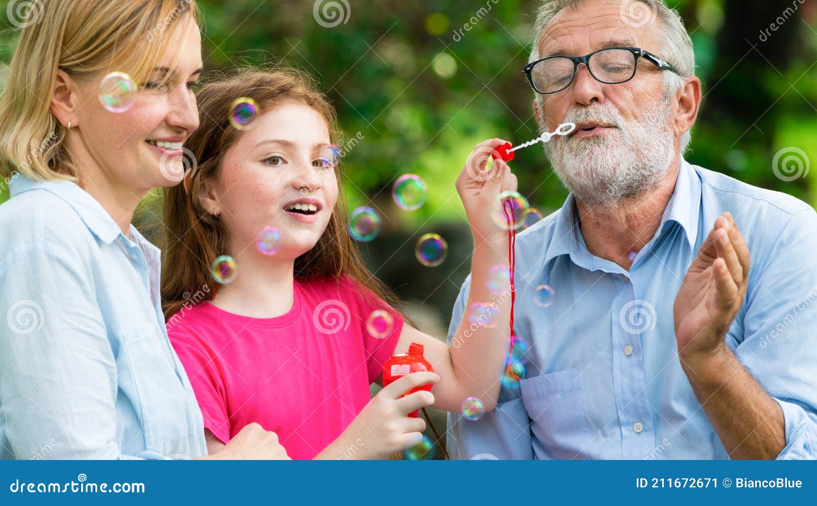 Happy Family Blowing Soap Bubbles in the Park. Stock Image - Image of ...